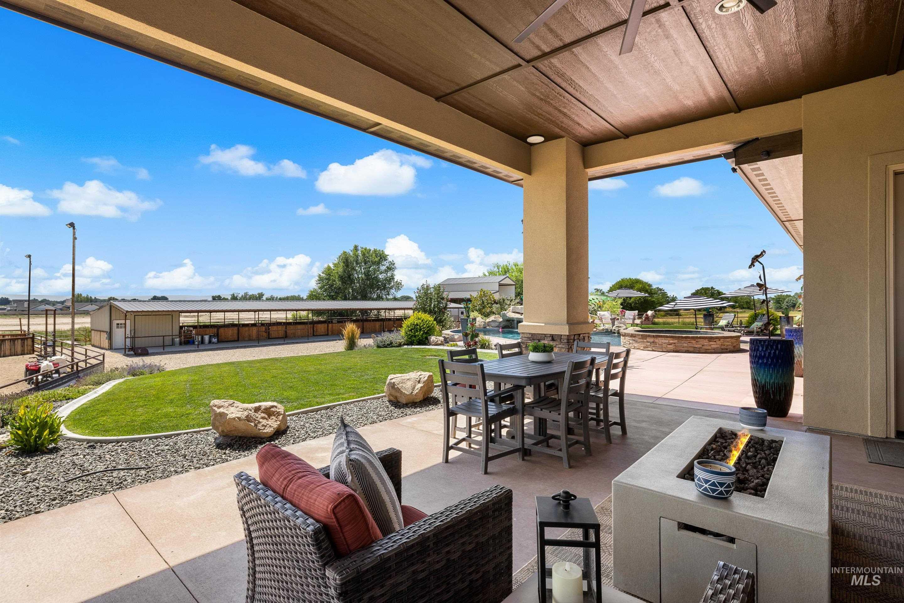 View of patio / terrace featuring outdoor dining area and a fire pit