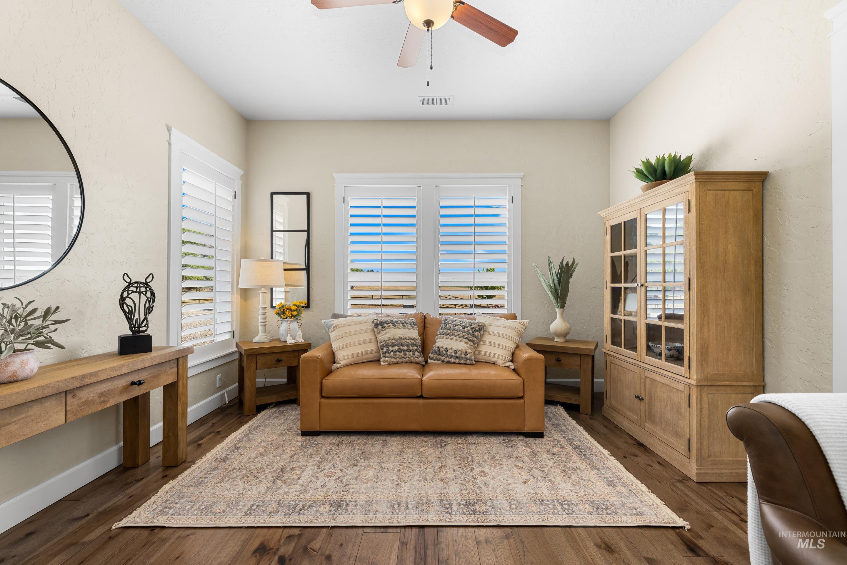 Office area featuring wood finished floors, a ceiling fan, and plenty of natural light