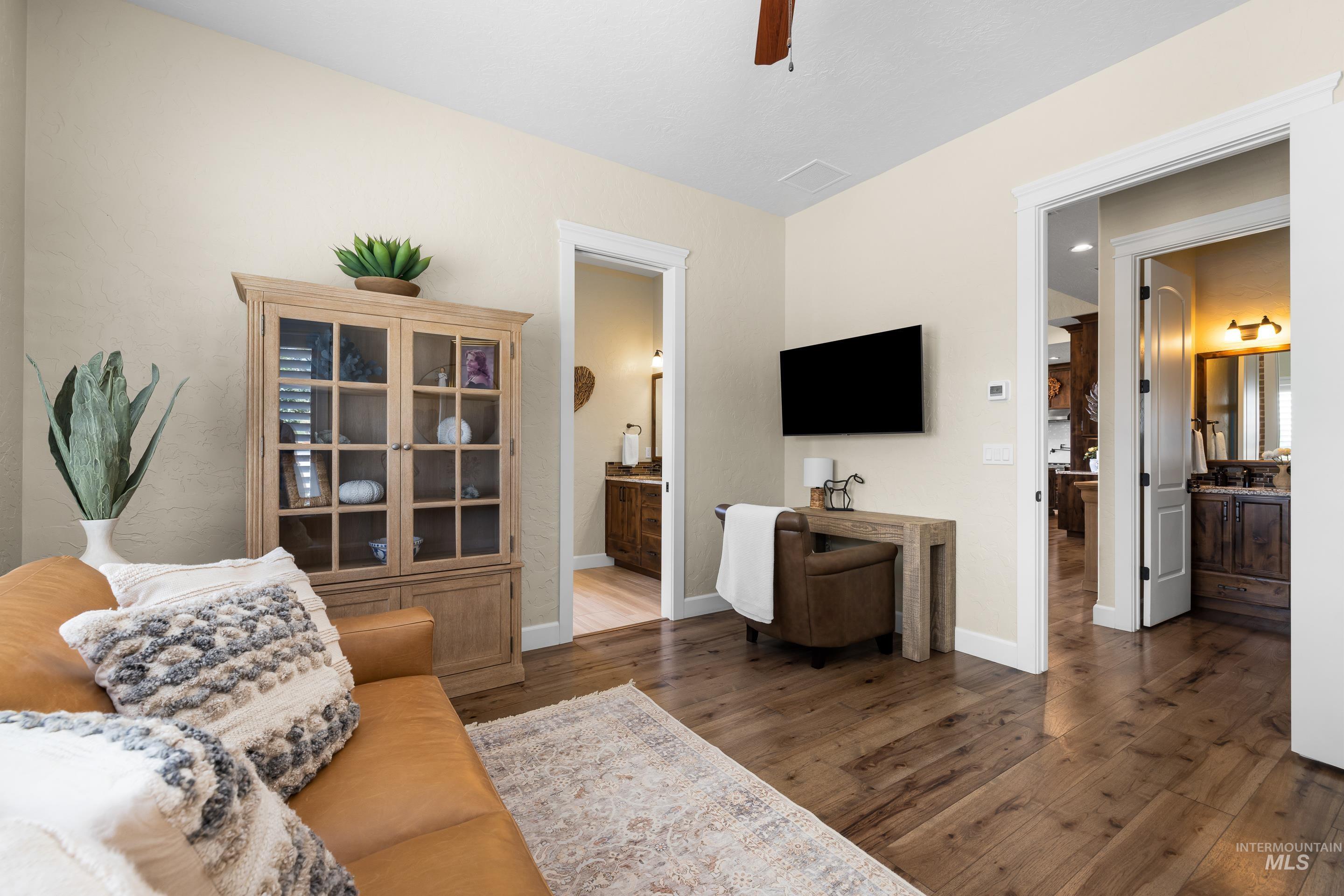 Living room featuring wood finished floors, ceiling fan, and recessed lighting