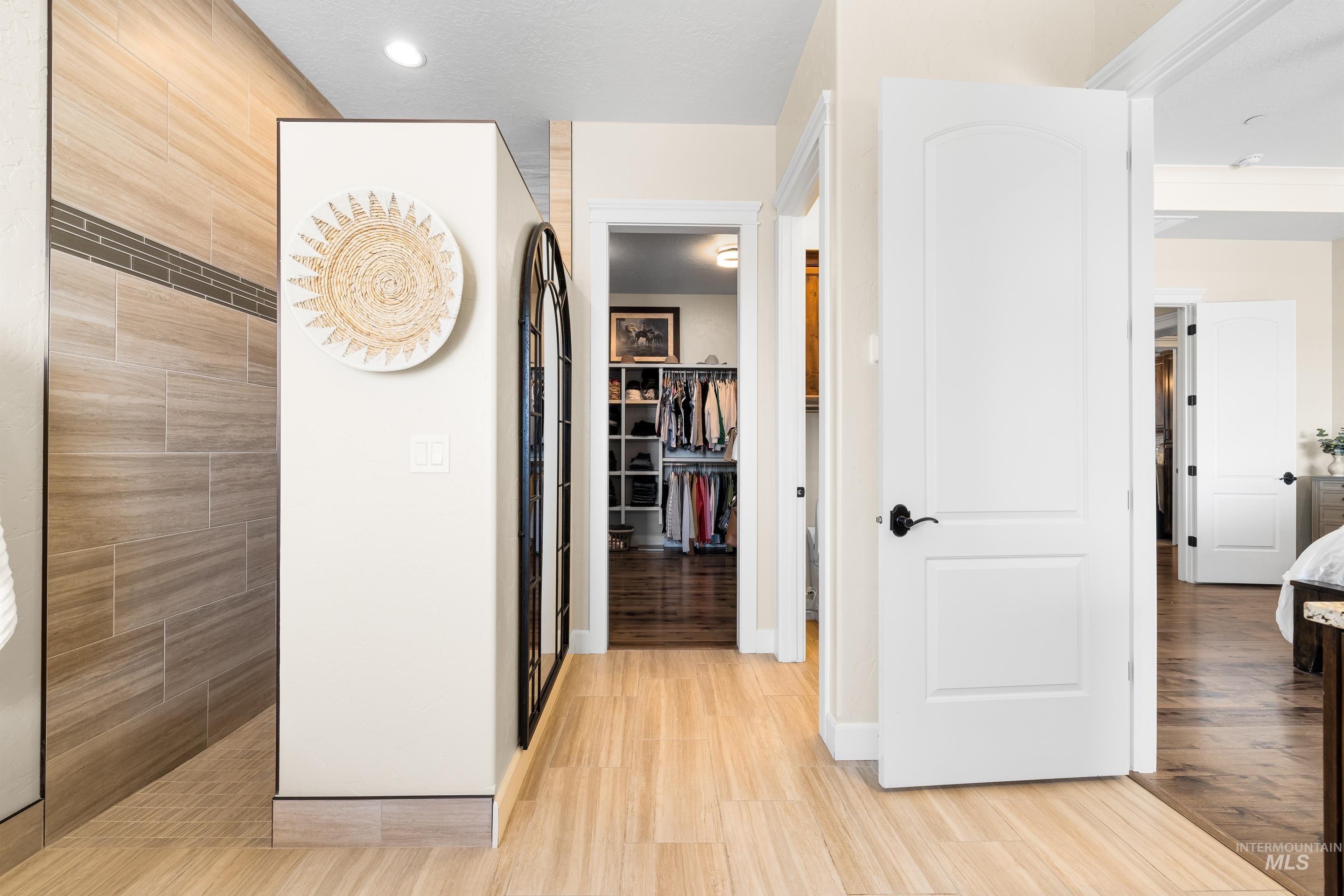 Corridor with light wood finished floors and baseboards