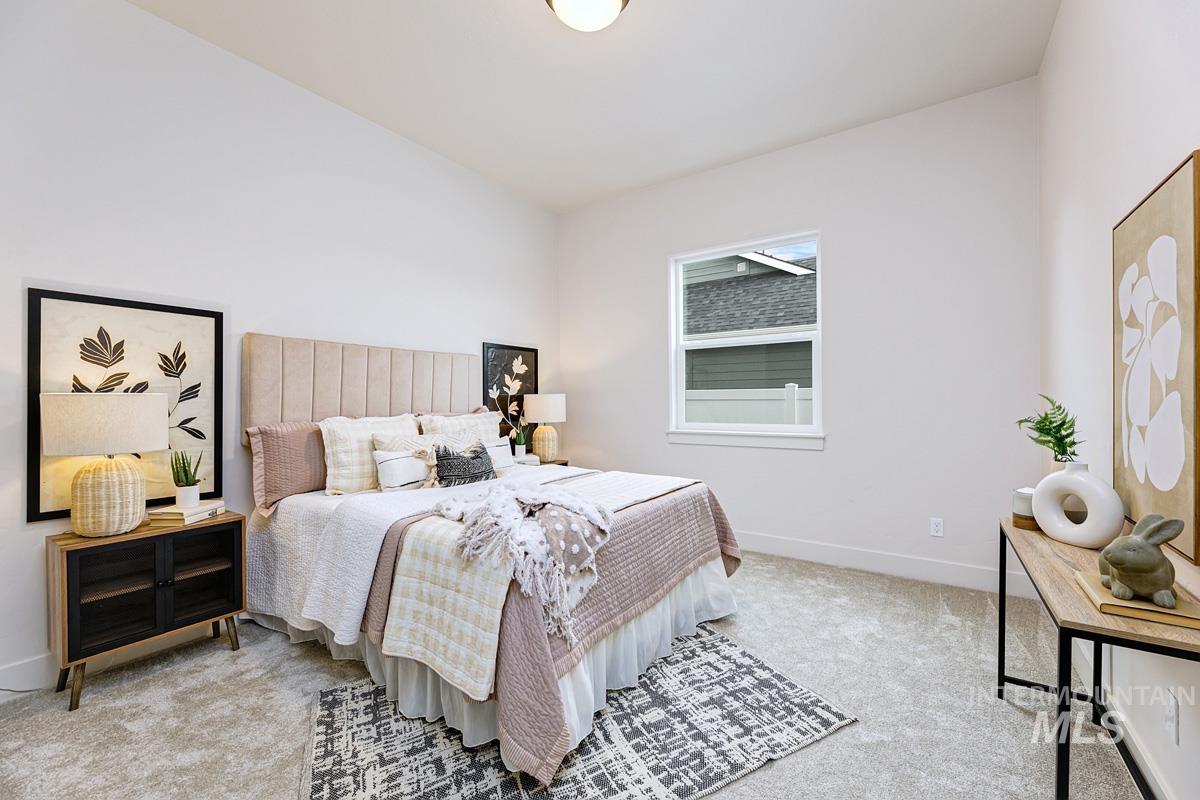 Bedroom with light carpet and baseboards
