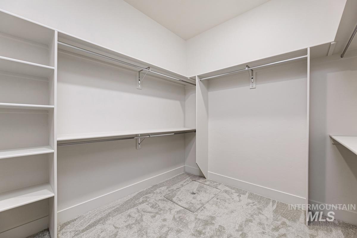 Spacious closet with light colored carpet