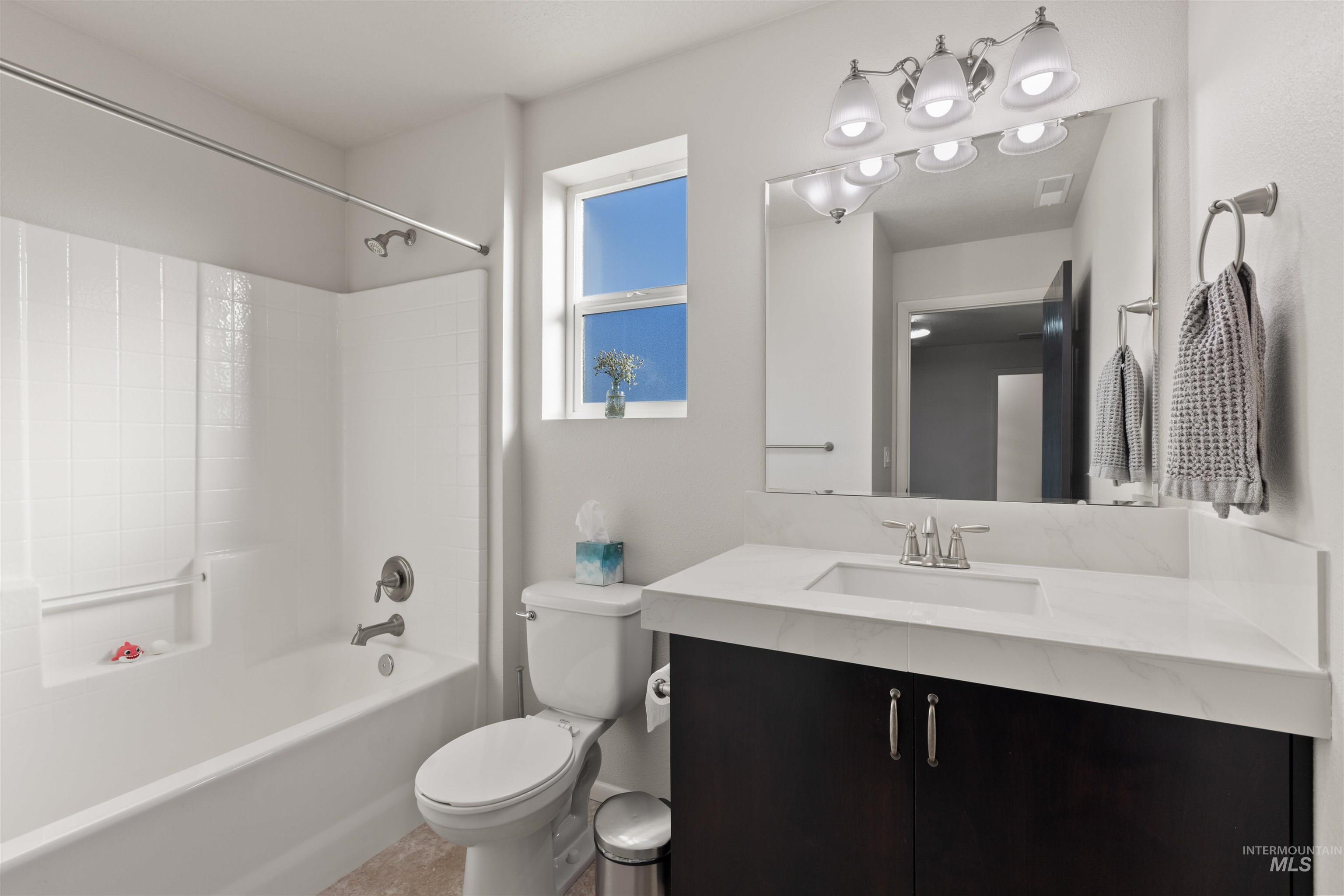 Bathroom featuring vanity and shower / tub combination