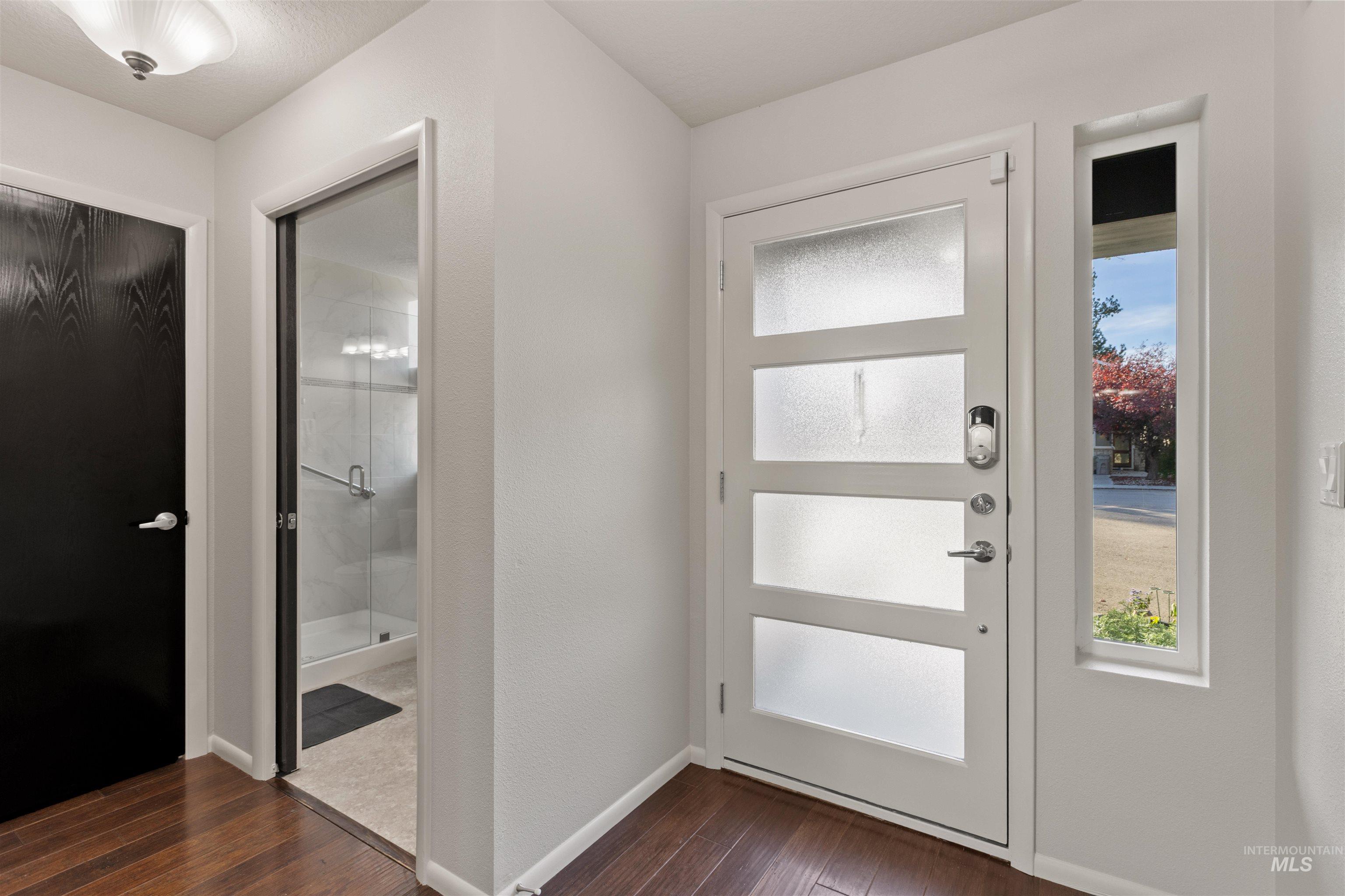 Foyer entrance featuring dark wood-style flooring