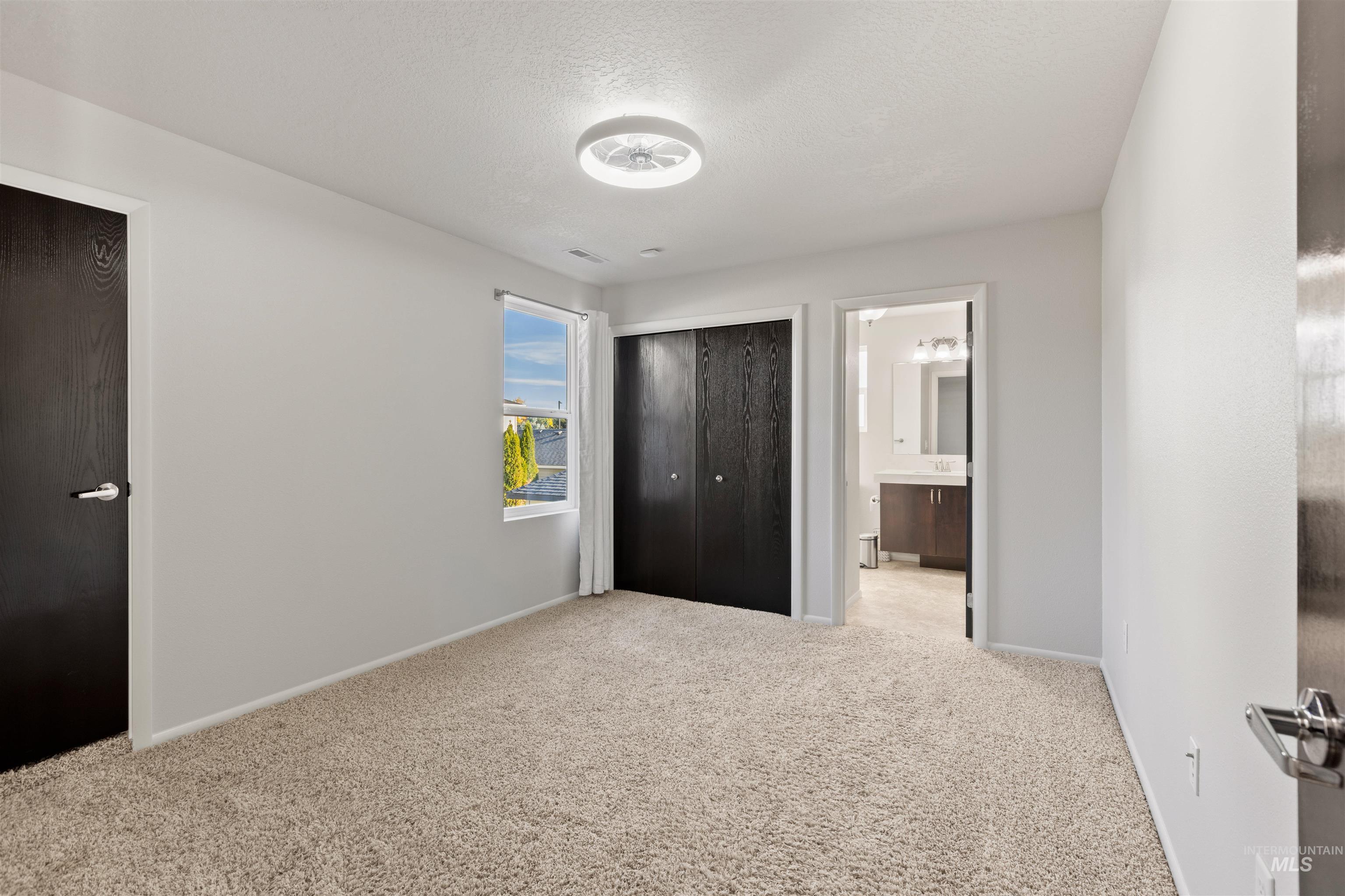 Unfurnished bedroom with carpet floors, a closet, and a textured ceiling