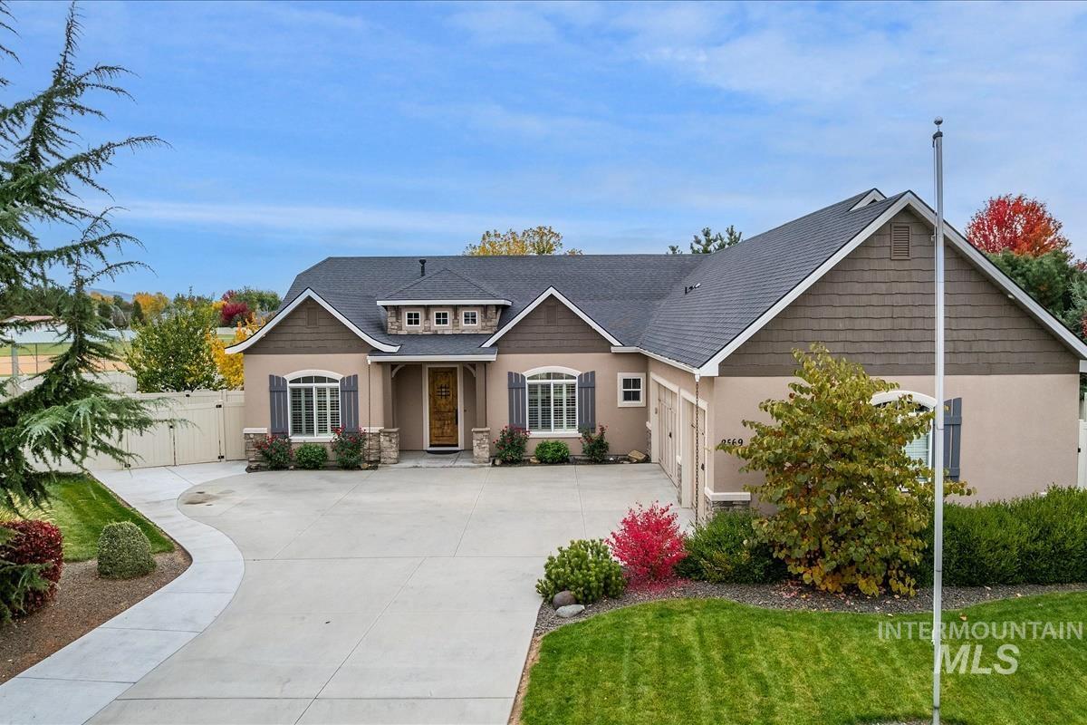 Craftsman house with stucco siding, a shingled roof, and concrete driveway