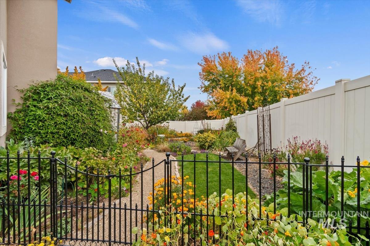 Gate with a fenced backyard and a balcony