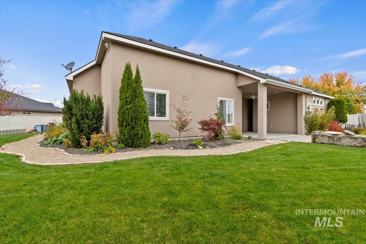 Back of property featuring stucco siding and a patio