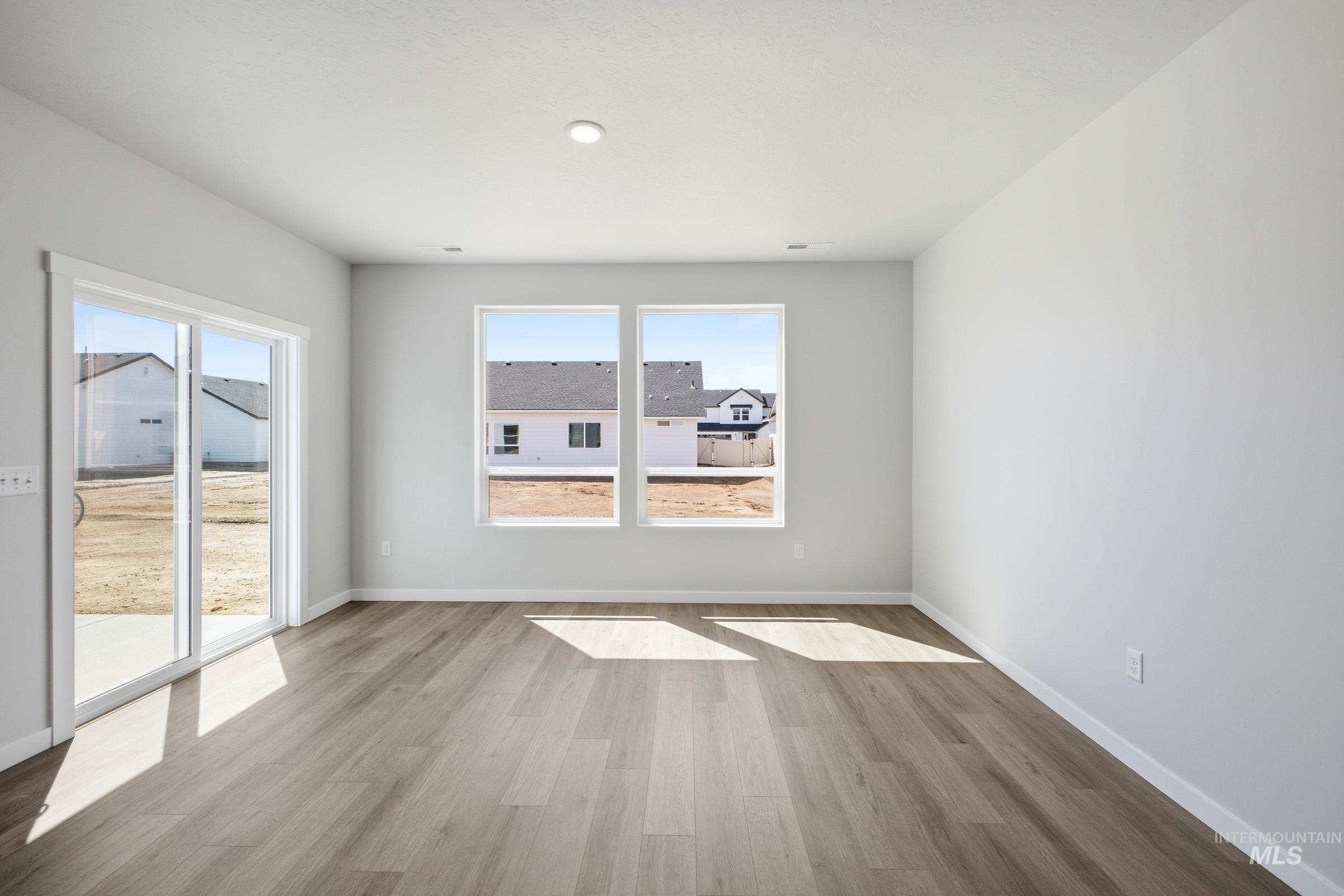 Bright interior space featuring wood-finish flooring