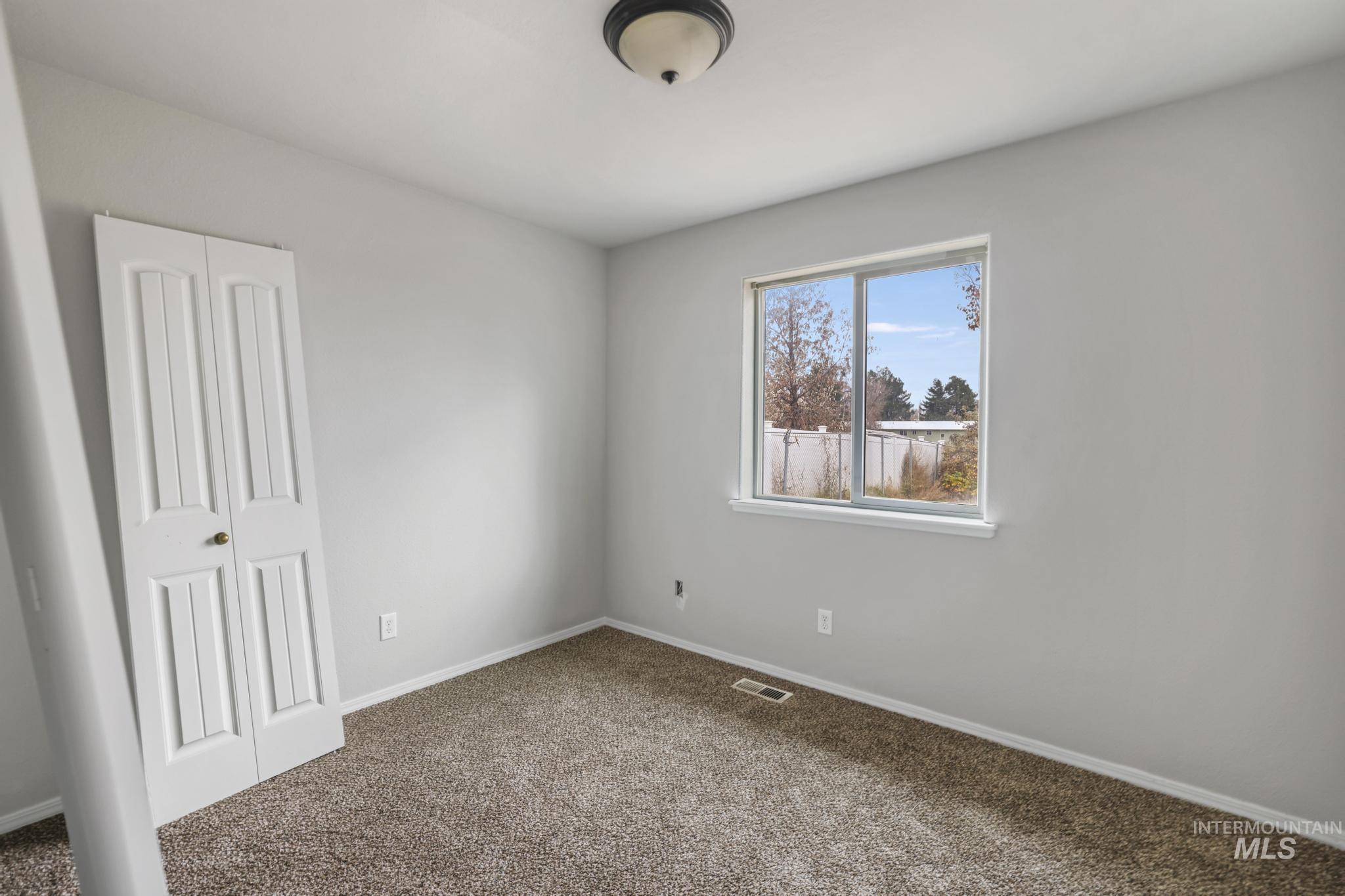 Unfurnished bedroom featuring carpet floors and a closet