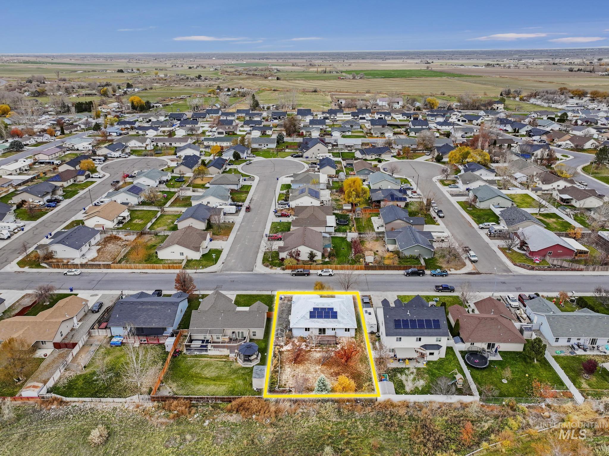 Aerial view of residential area featuring property boundaries highlighted