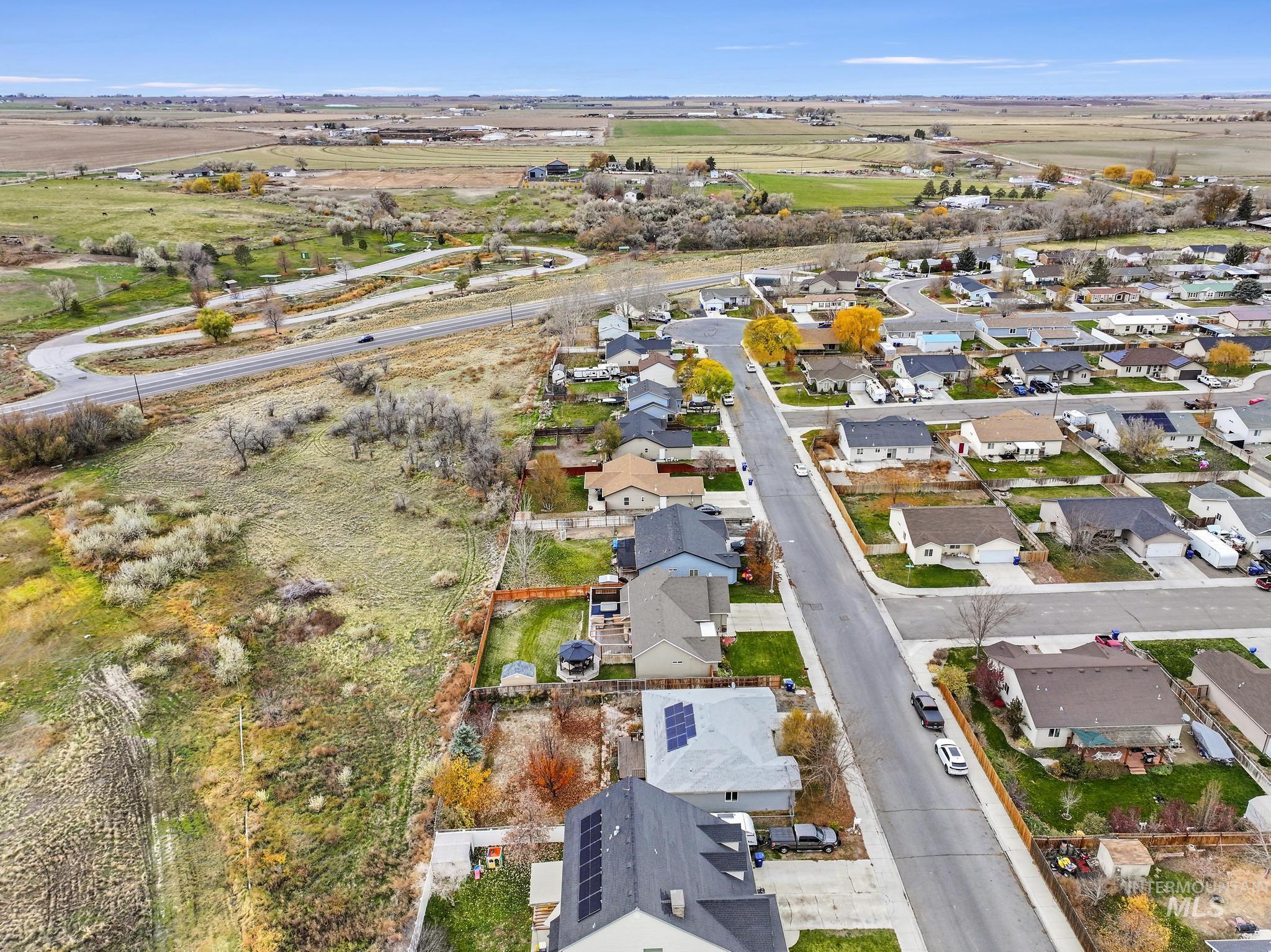 Aerial view of property's location featuring nearby suburban area