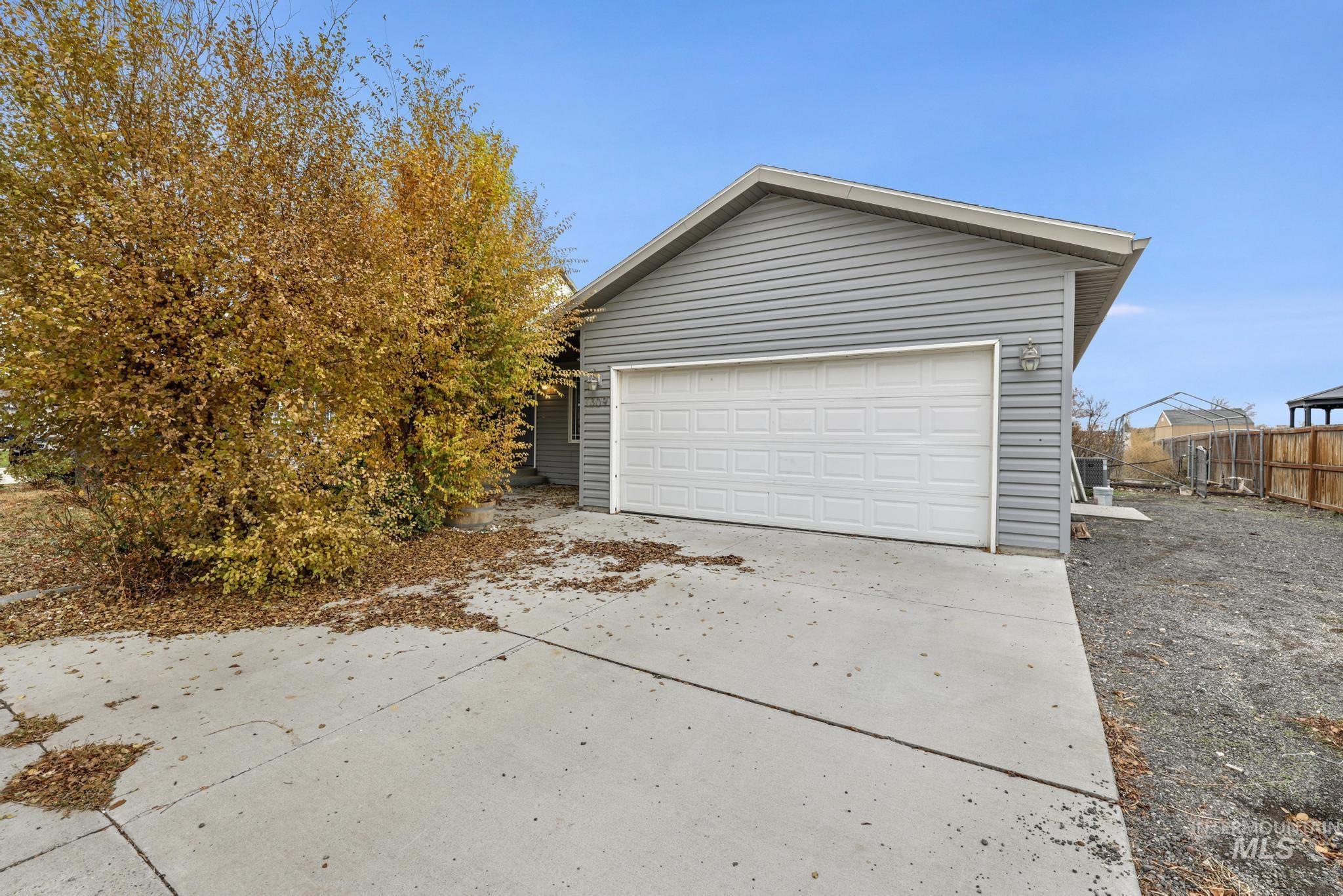 Garage featuring concrete driveway