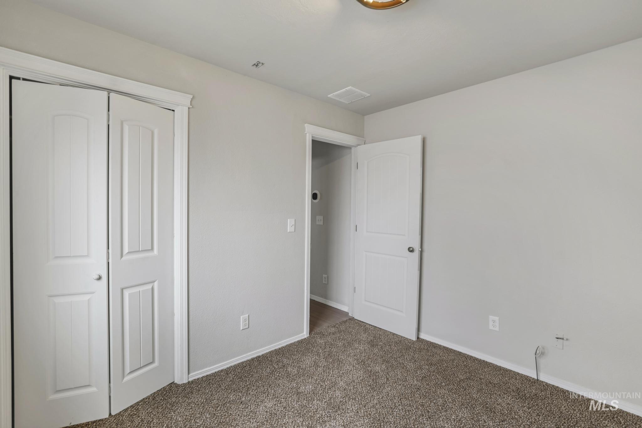 Unfurnished bedroom with carpet floors and a closet