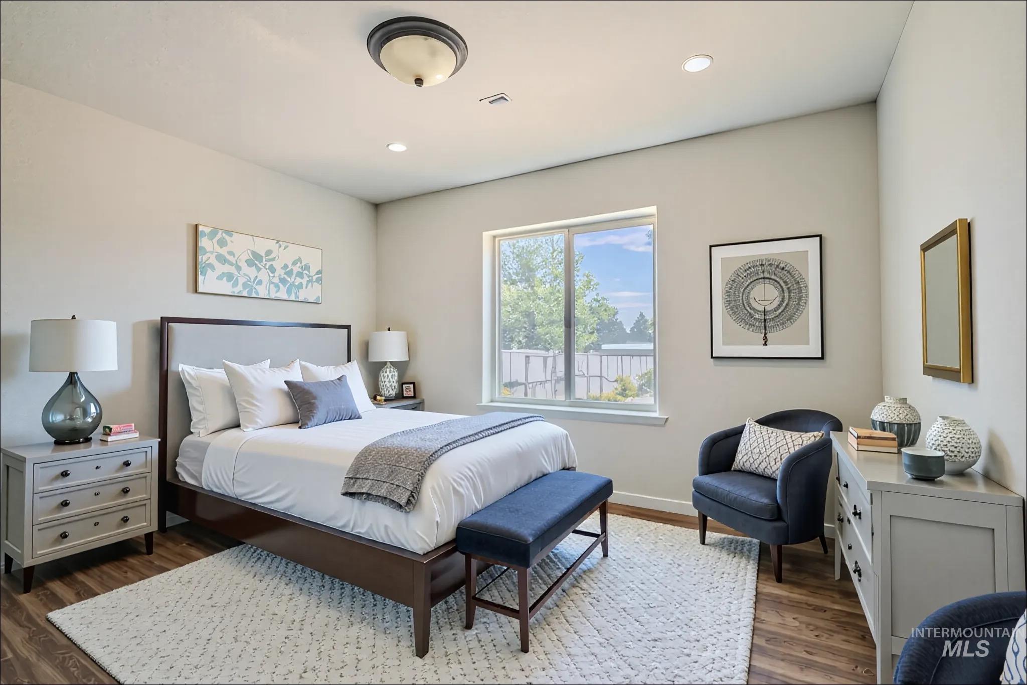 Bedroom with dark wood-style floors and recessed lighting