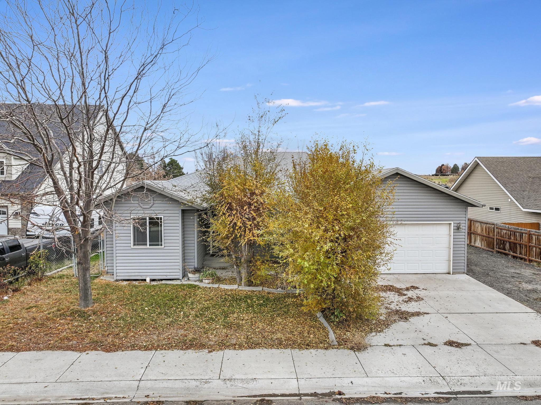 View of front facade featuring driveway and an attached garage