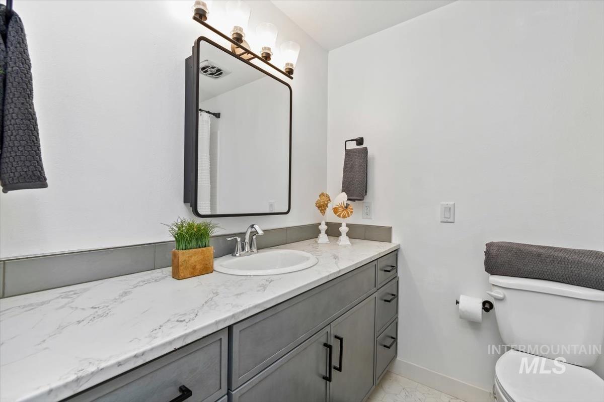 Full bathroom featuring vanity and a shower with curtain