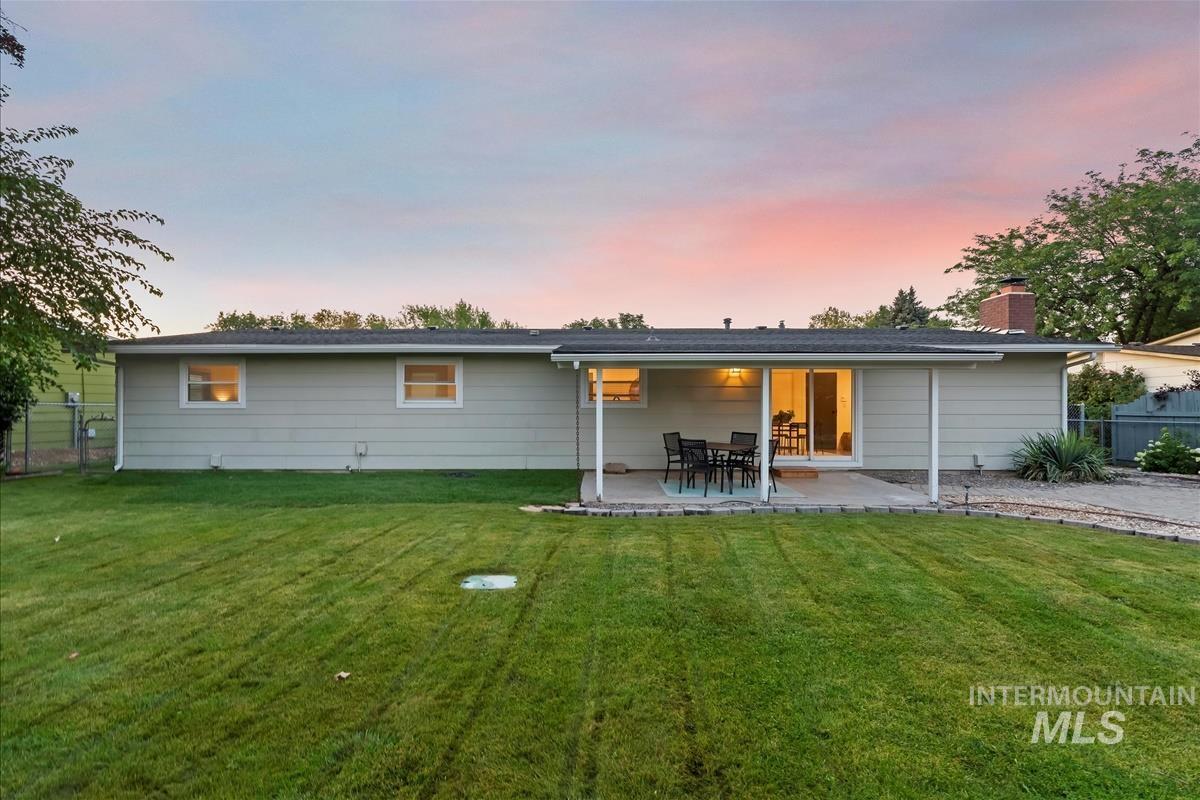 Rear view of property with a patio area and a chimney