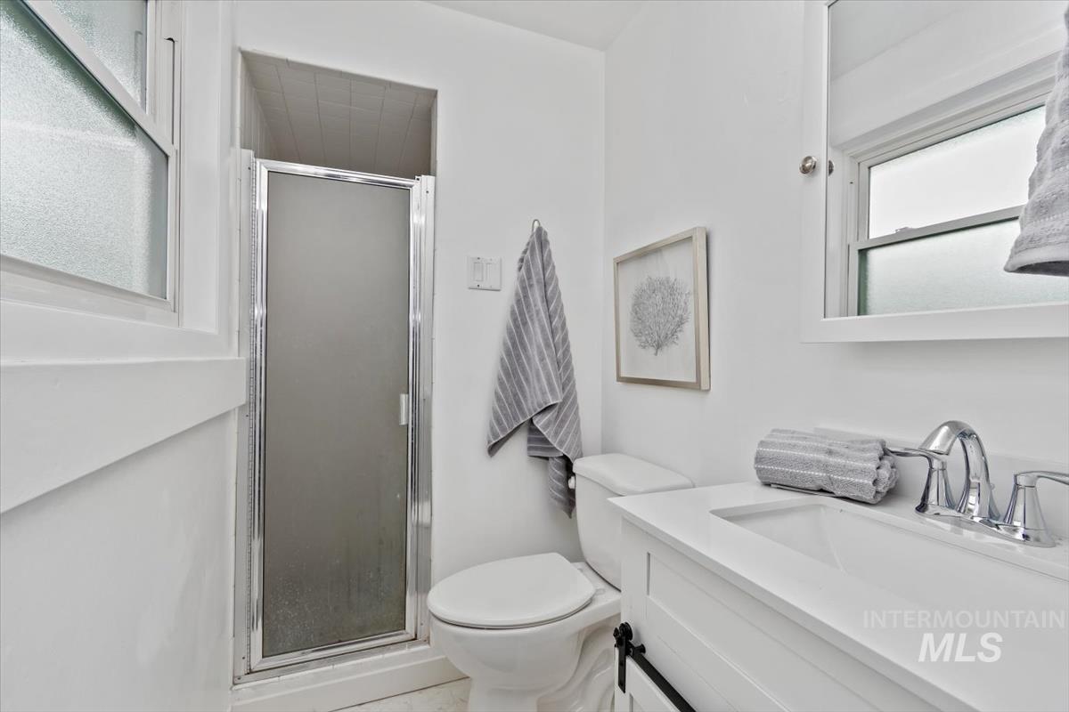Bathroom featuring vanity and a shower stall