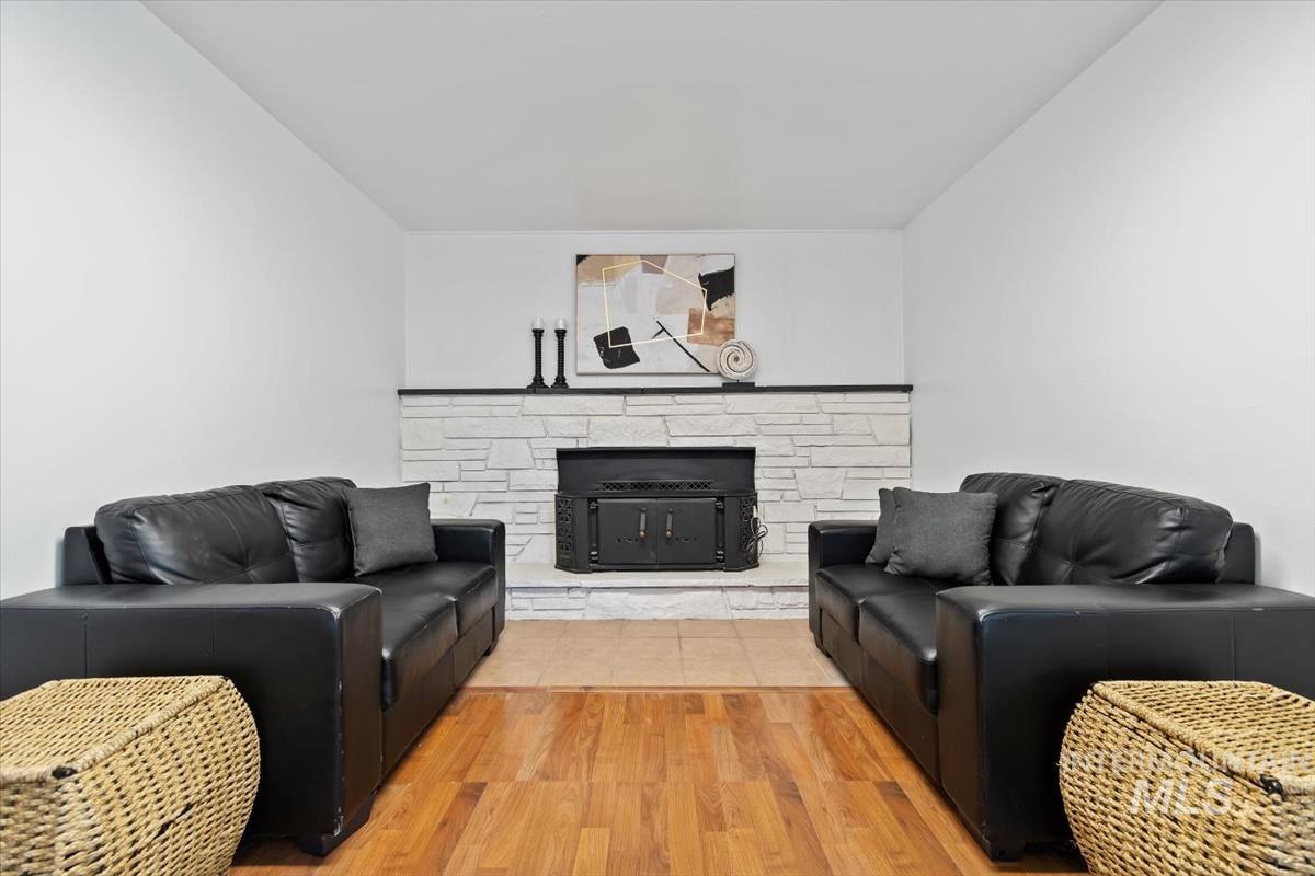 Living area featuring wood finished floors and a fireplace