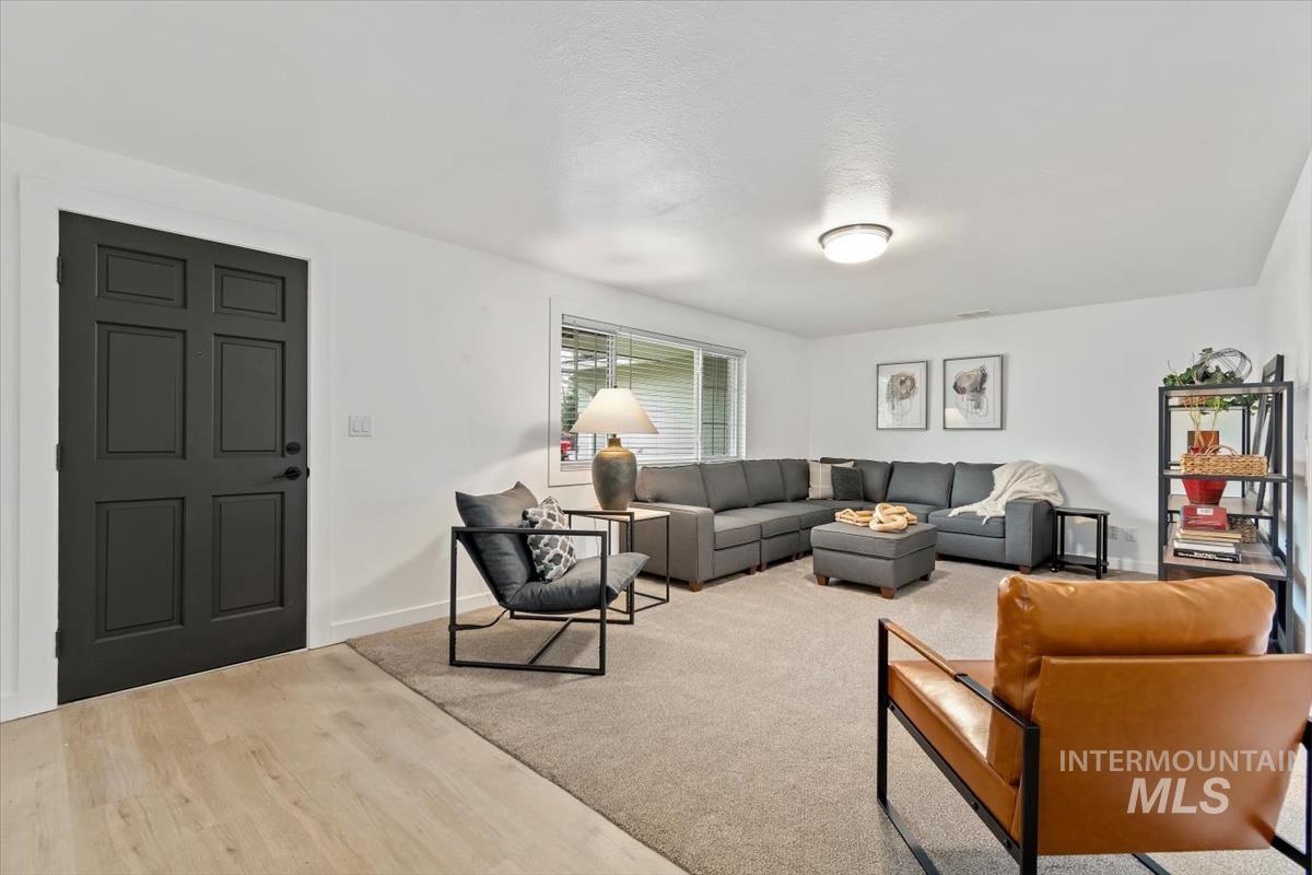 Living area with wood finished floors and a textured ceiling