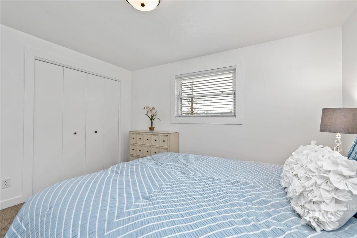 Carpeted bedroom featuring a closet