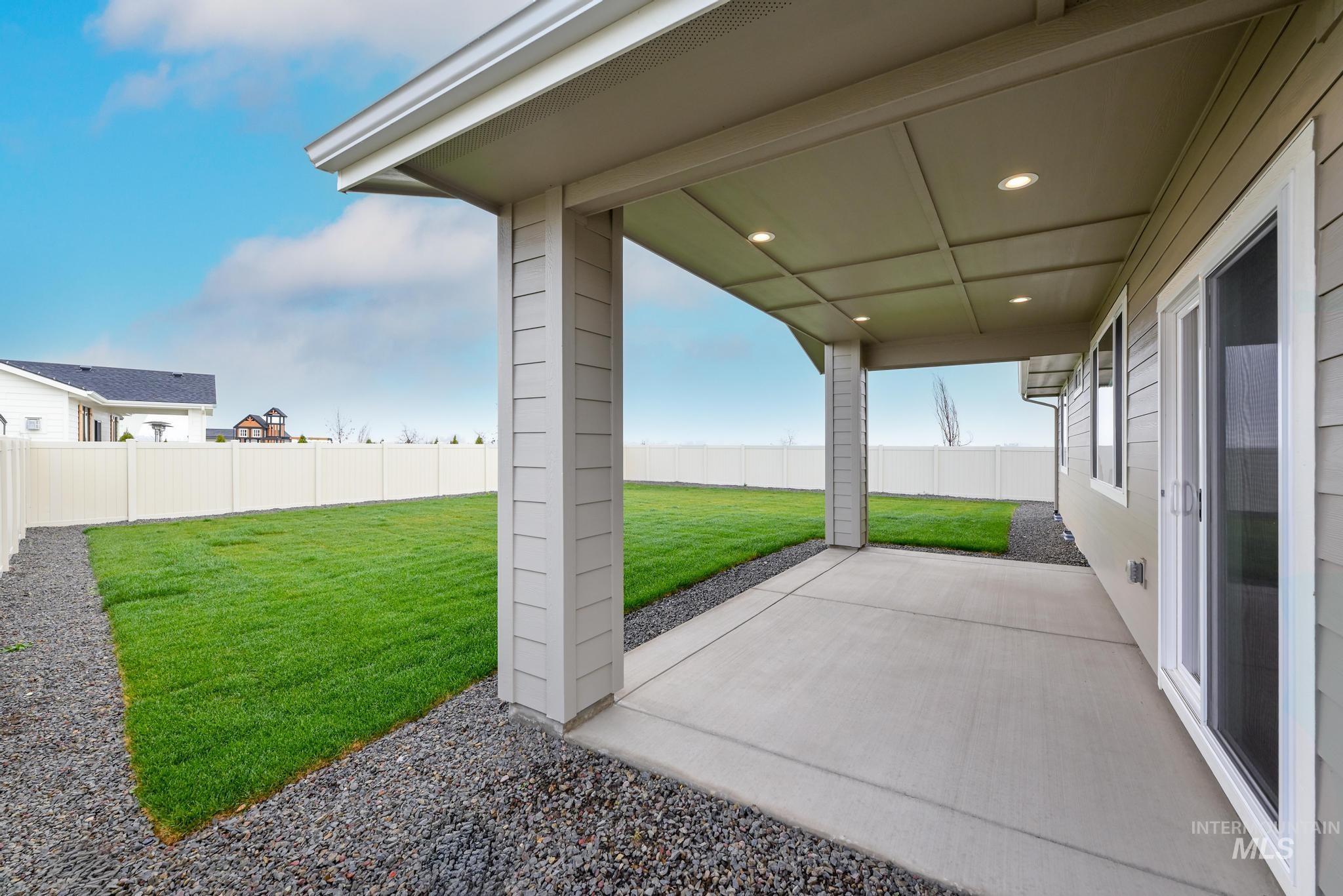 Fenced backyard featuring a patio