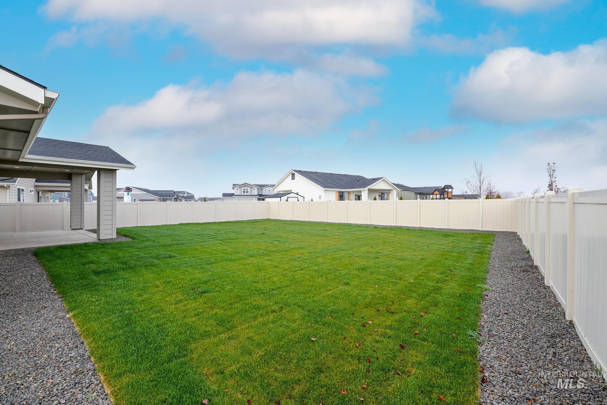 Fenced backyard featuring a patio and a residential view