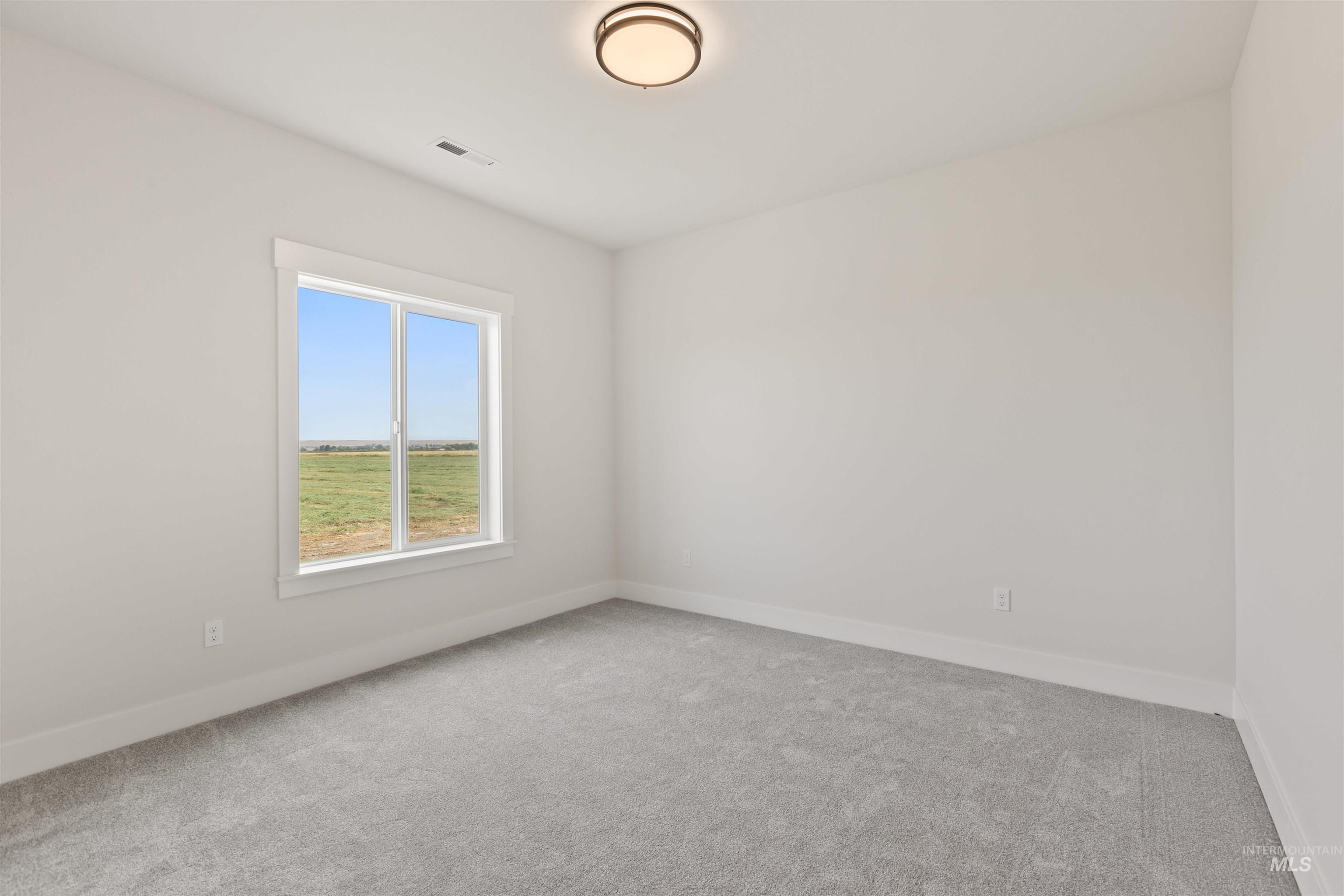 Empty room with light colored carpet