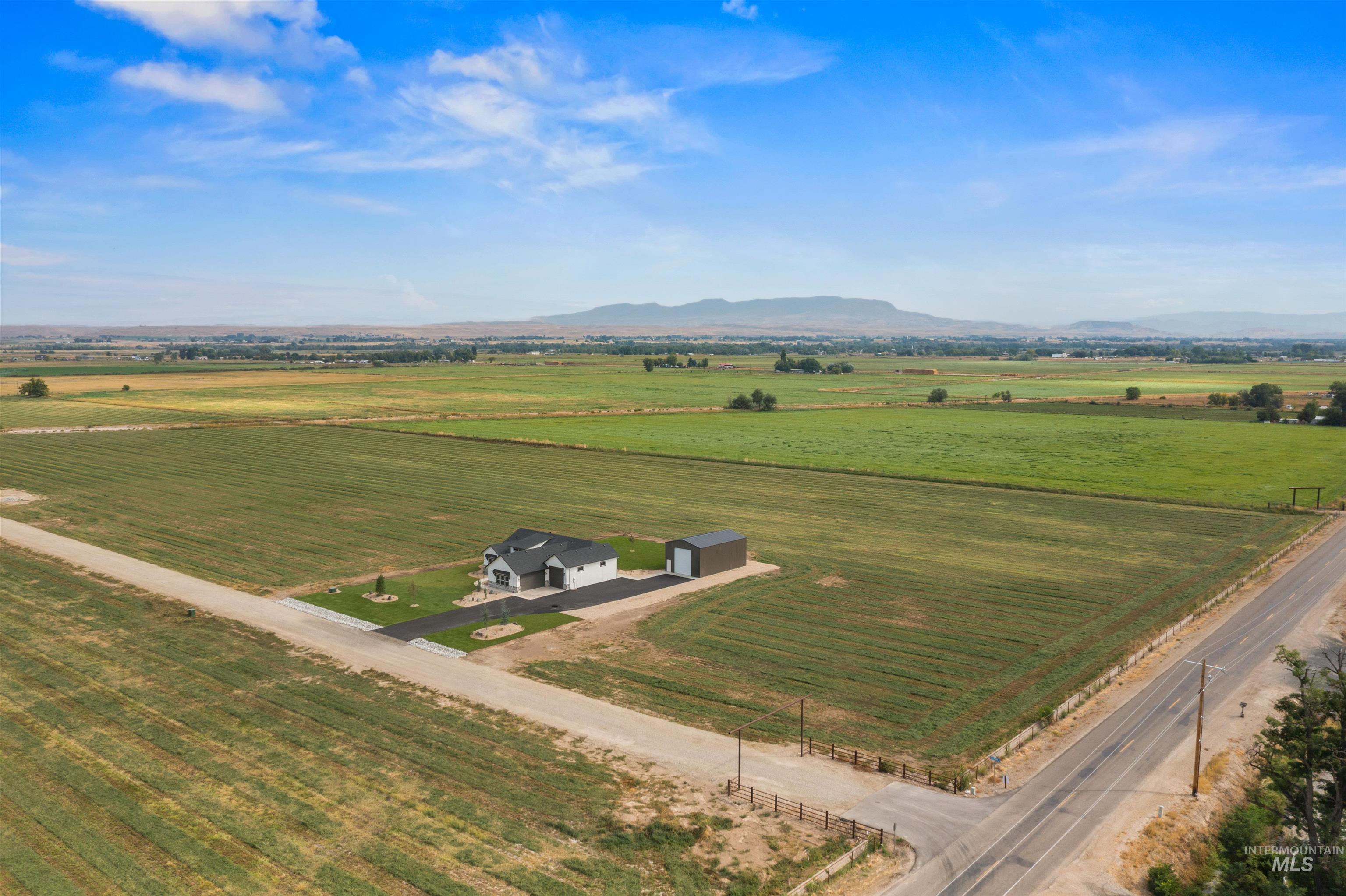Overview of rural landscape with a mountain backdrop and abundant farmland