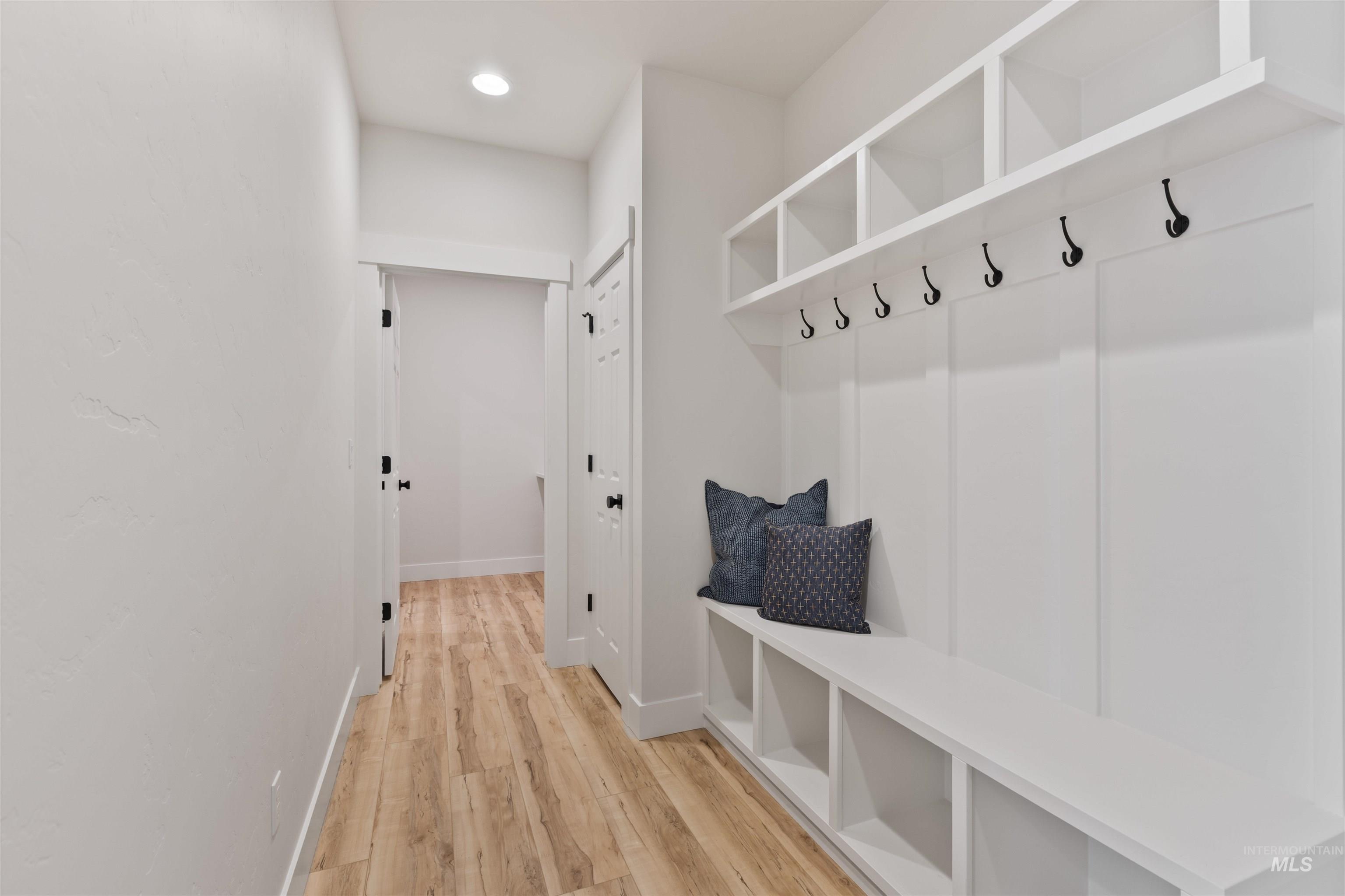 Mudroom with light wood-type flooring and recessed lighting