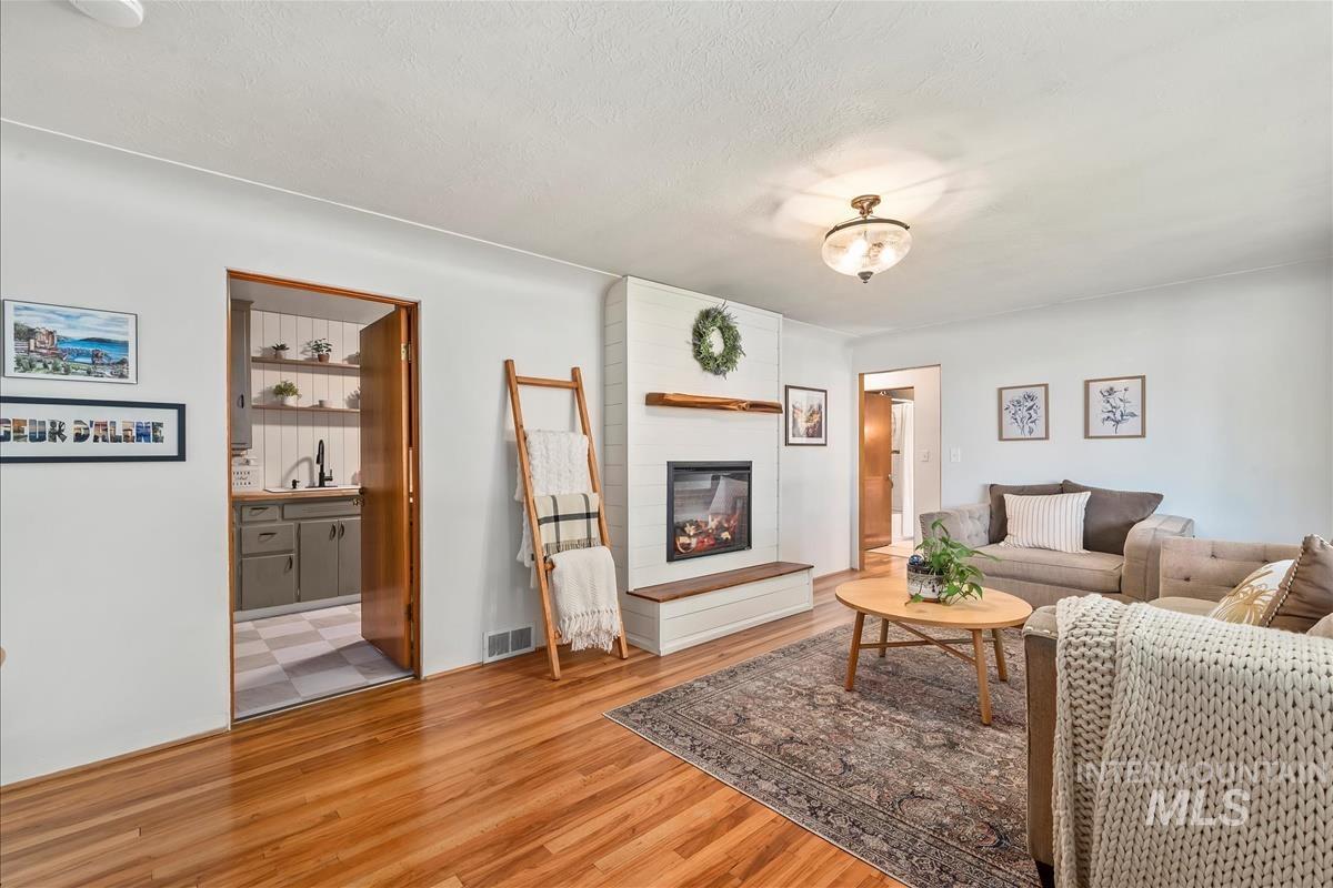 Living room featuring wood finished floors and a fireplace