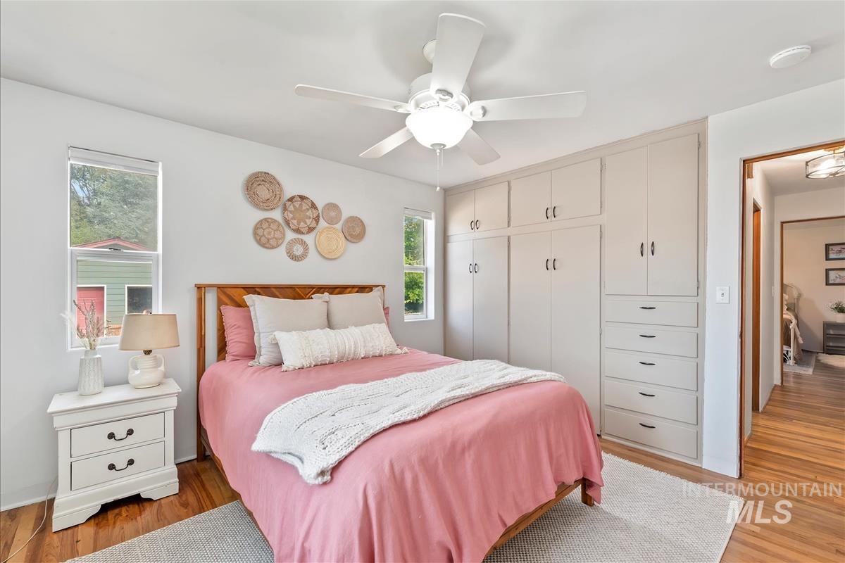 Bedroom featuring light wood-style floors, a closet, and ceiling fan