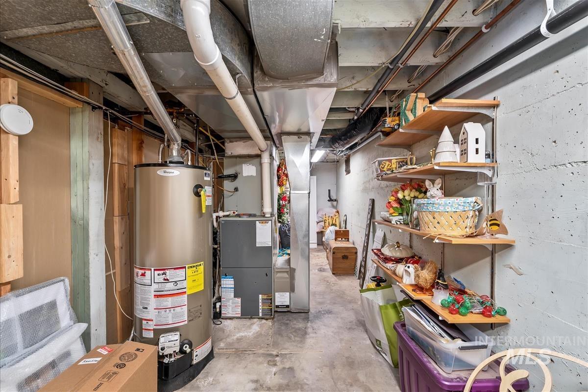 Unfinished basement with gas water heater and heating unit