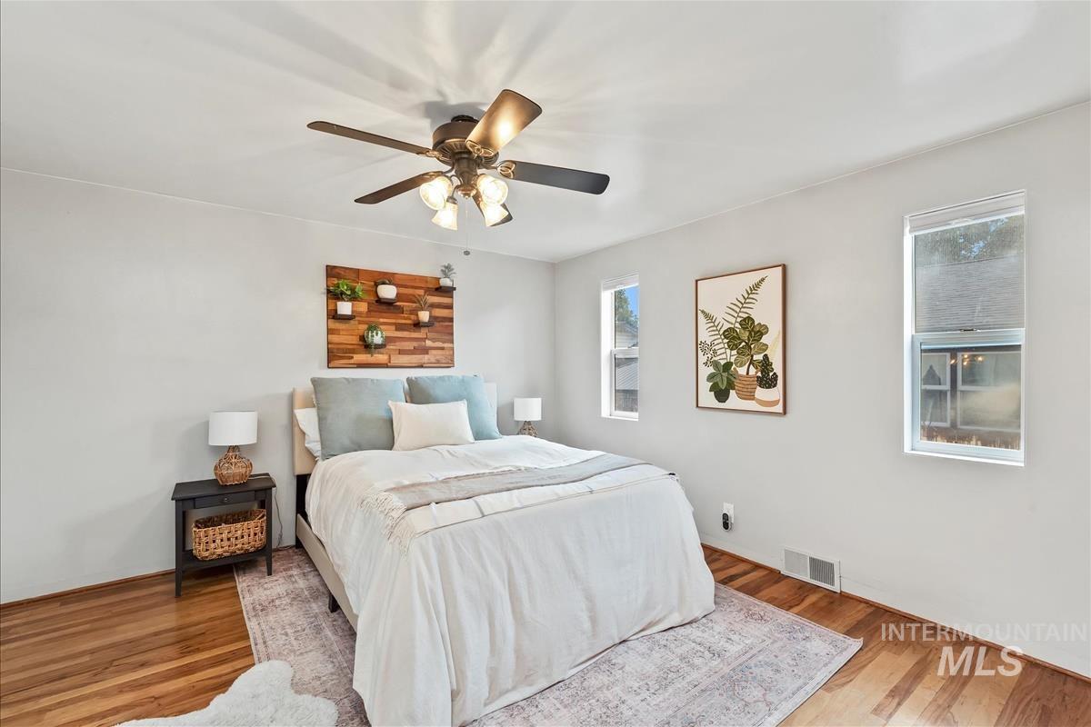 Bedroom with wood finished floors and a ceiling fan