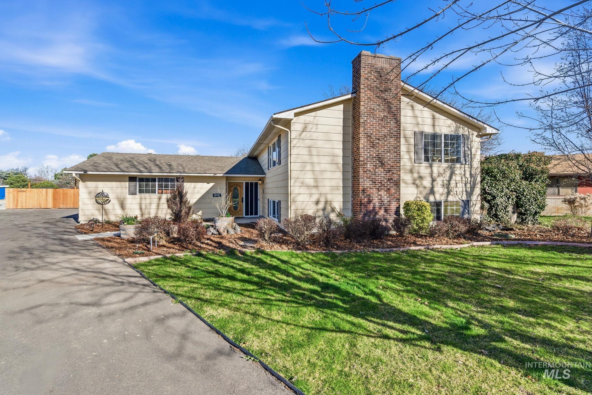 Tri-level home featuring a chimney