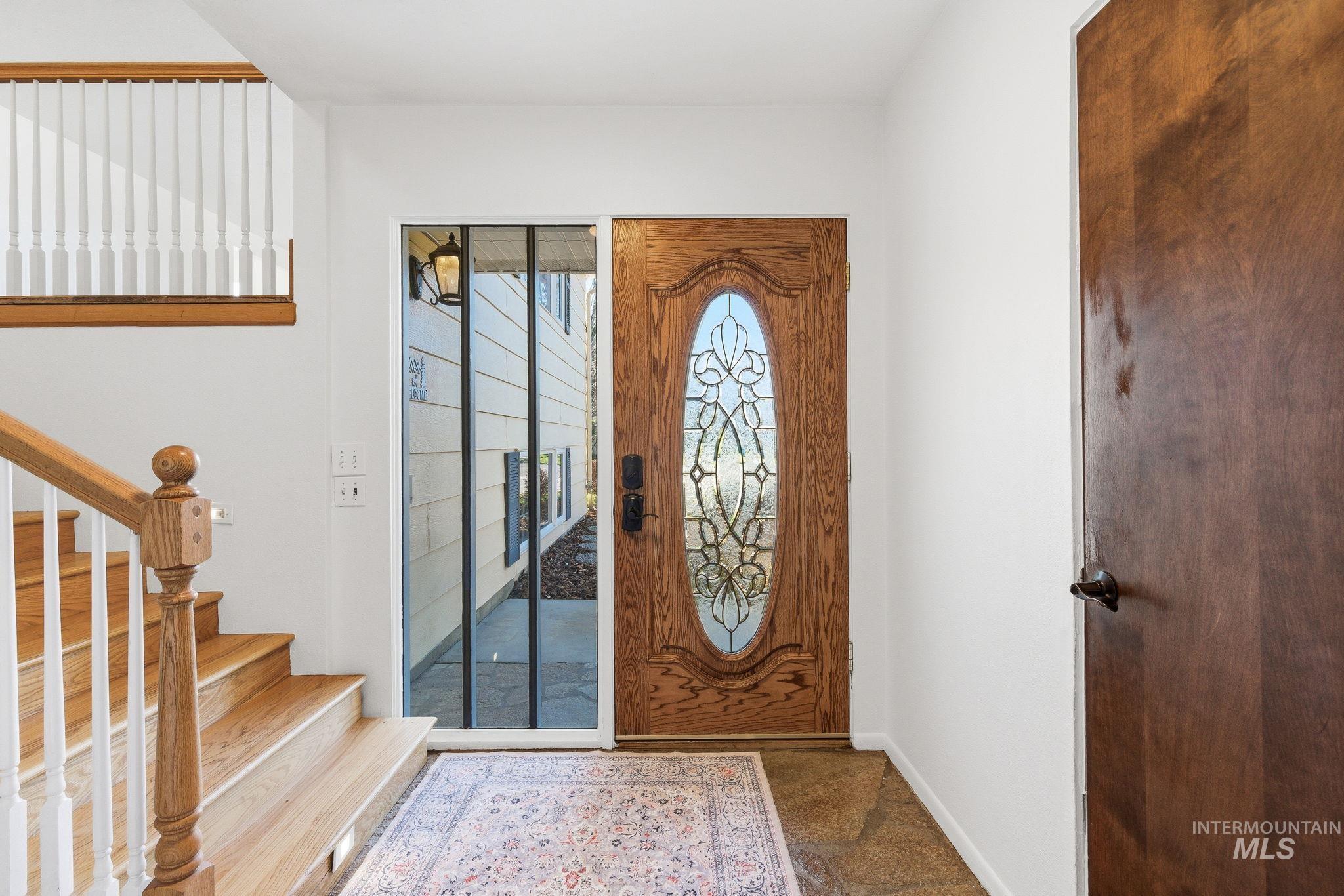 Entryway featuring stairway and baseboards
