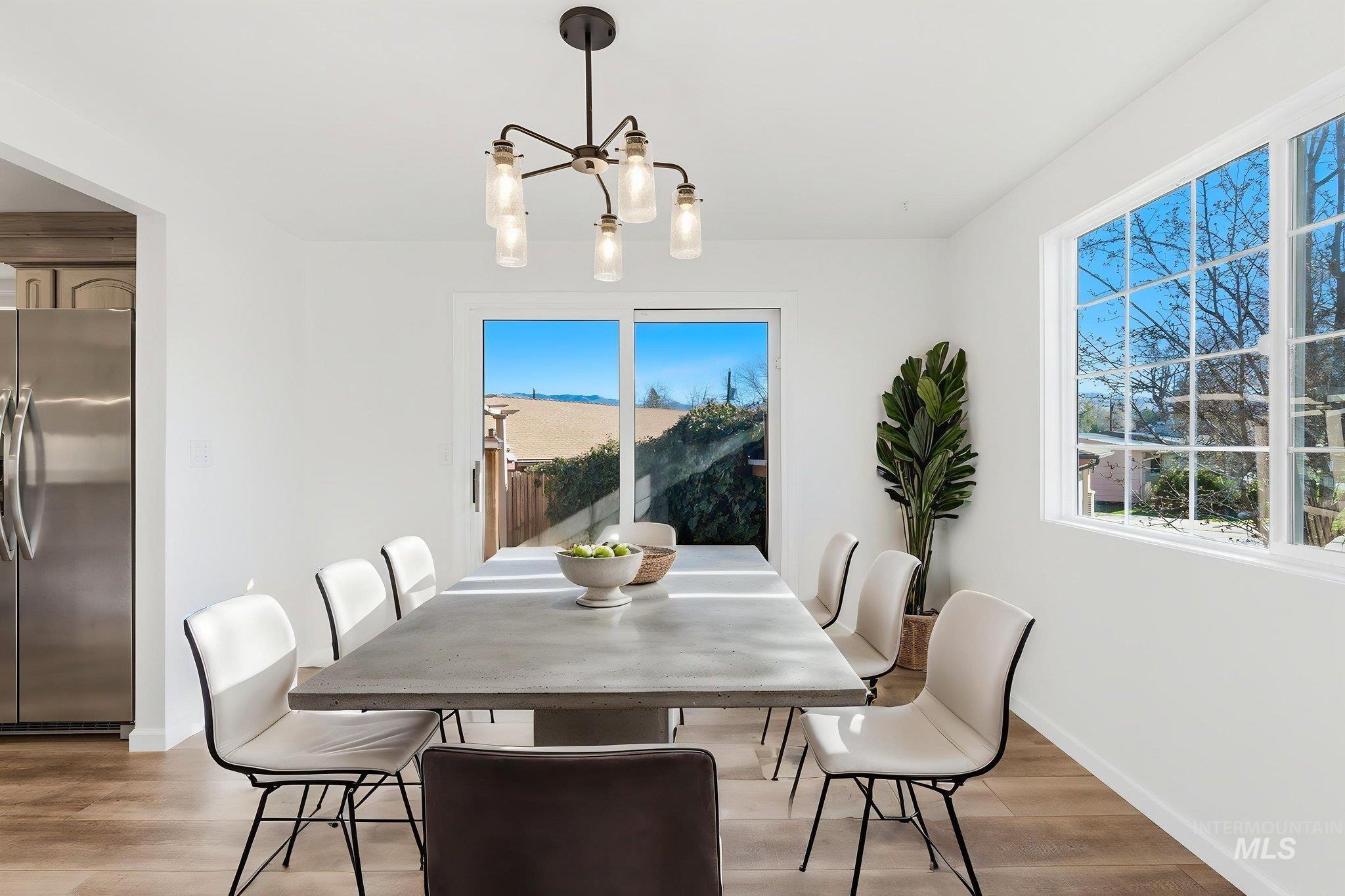 Dining area featuring light wood-style floors and hanging lights