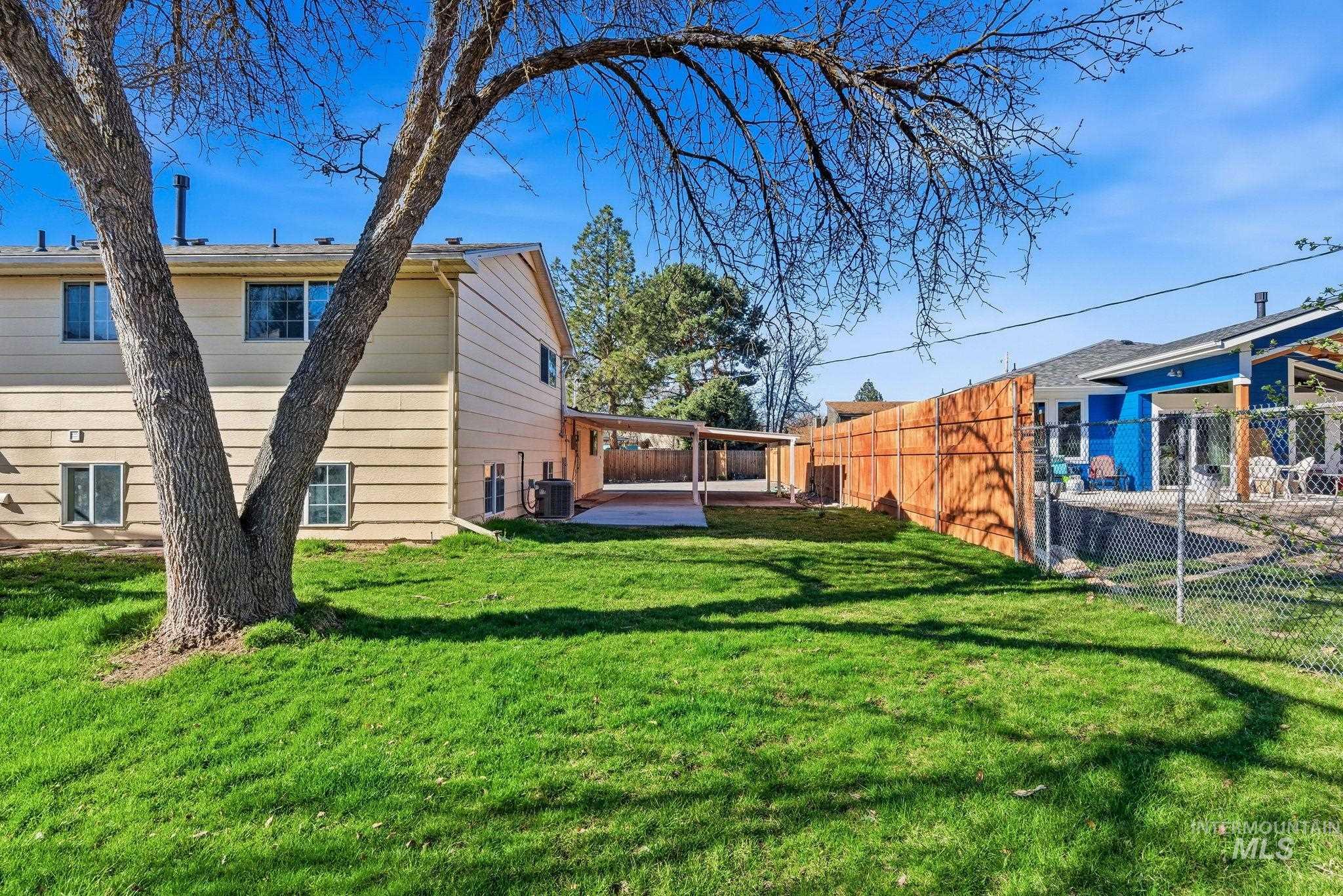 View of side of property featuring a patio and a fenced backyard