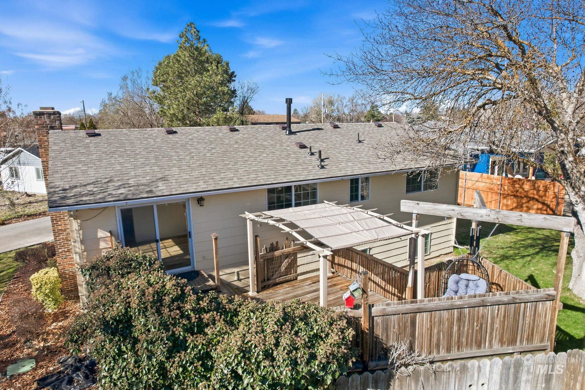 Back of property with roof with shingles