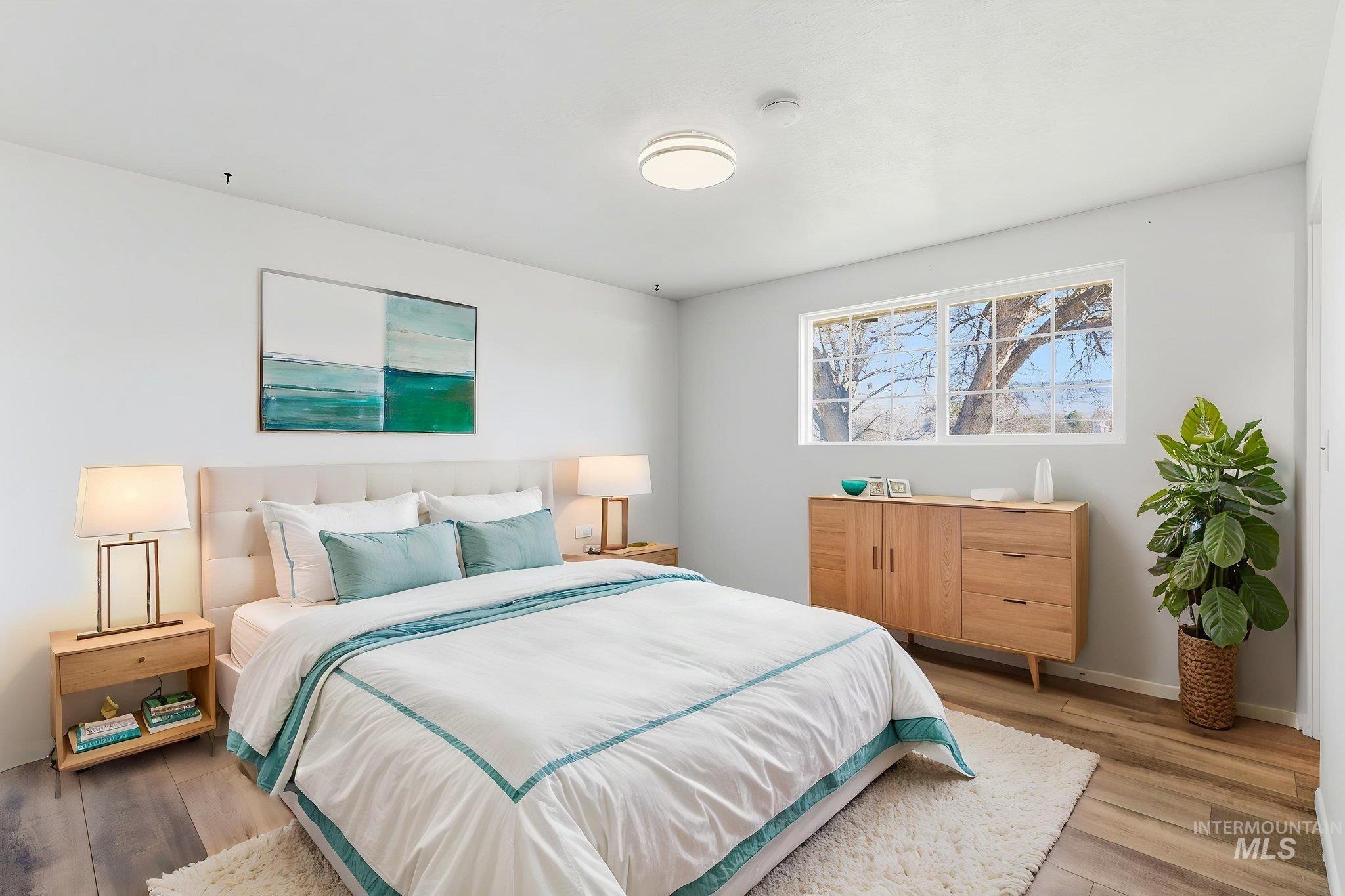 Bedroom with light wood-type flooring and baseboards