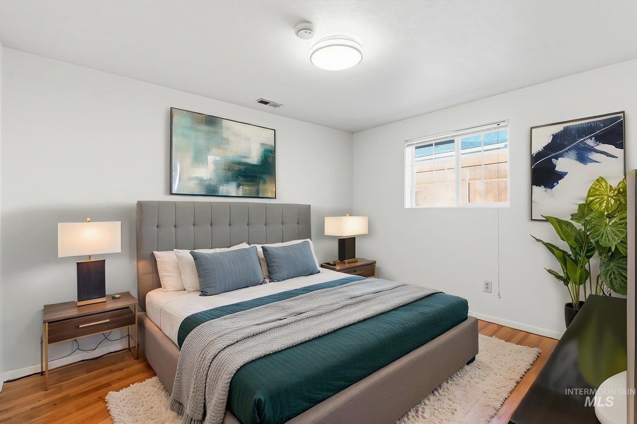 Bedroom featuring light wood-type flooring and baseboards