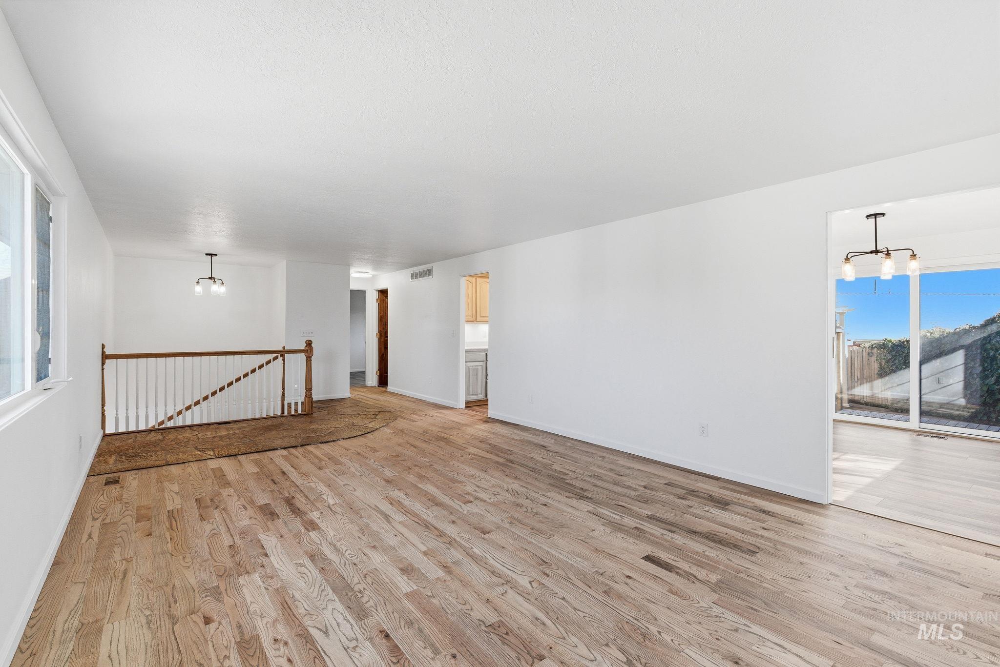 Unfurnished room featuring a chandelier and light wood finished floors