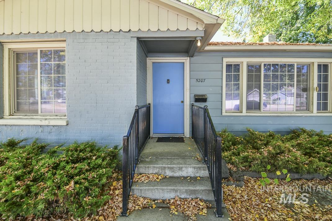 Entrance to property featuring brick siding and board and batten siding