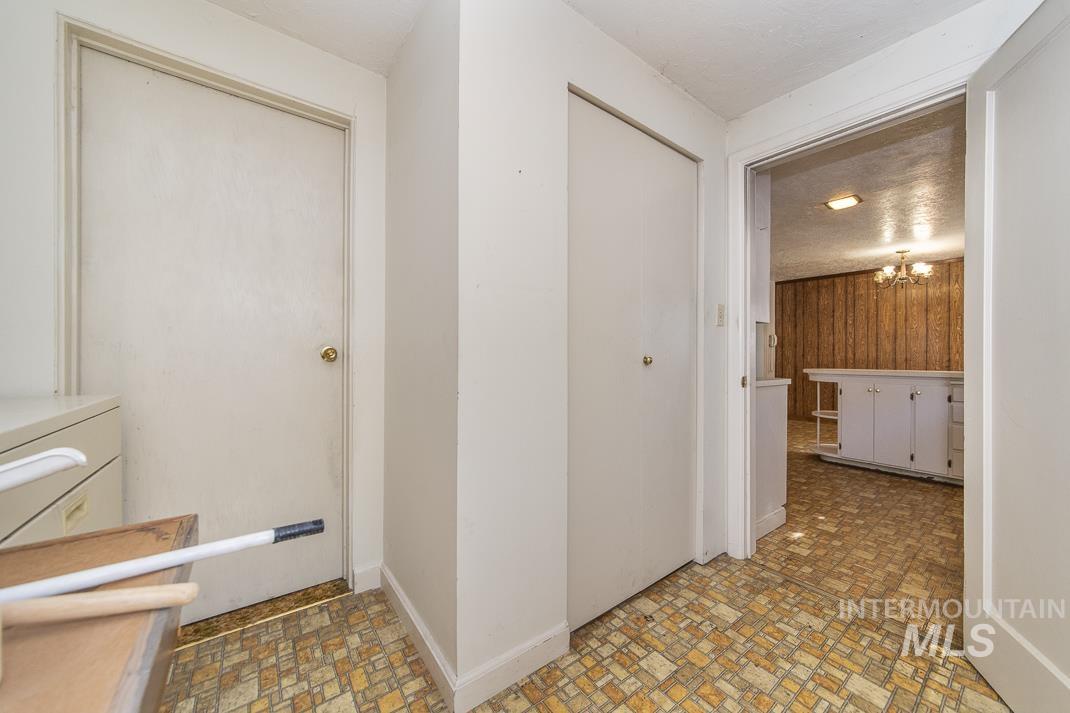 Corridor with a chandelier and brick patterned floors