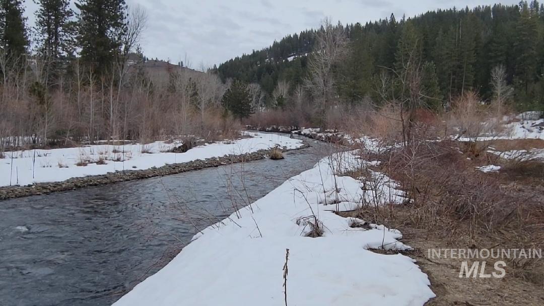 Water view with a forest and mountains