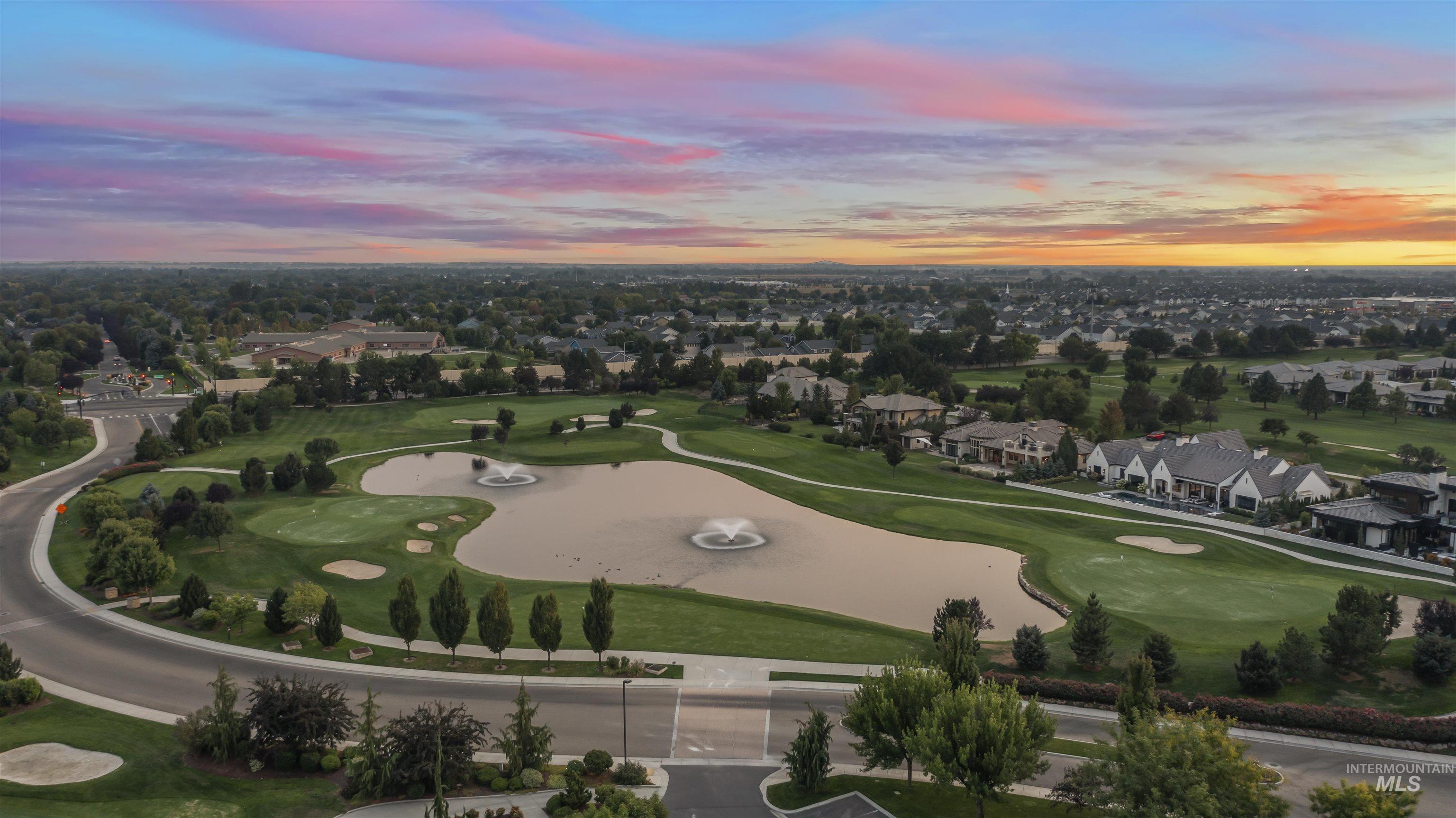 Aerial overview of property's location with nearby suburban area, a nearby body of water, and a golf club