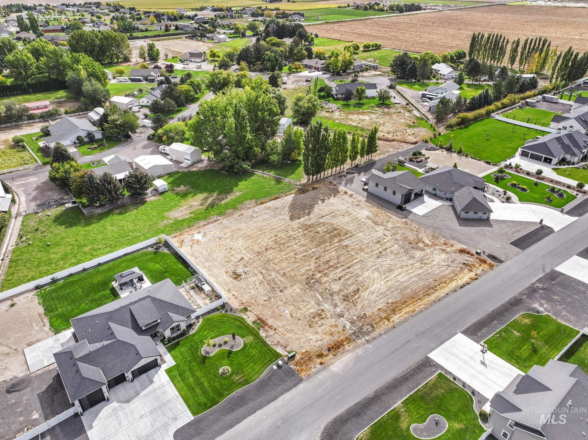 View of rural area featuring nearby suburban area and farmland