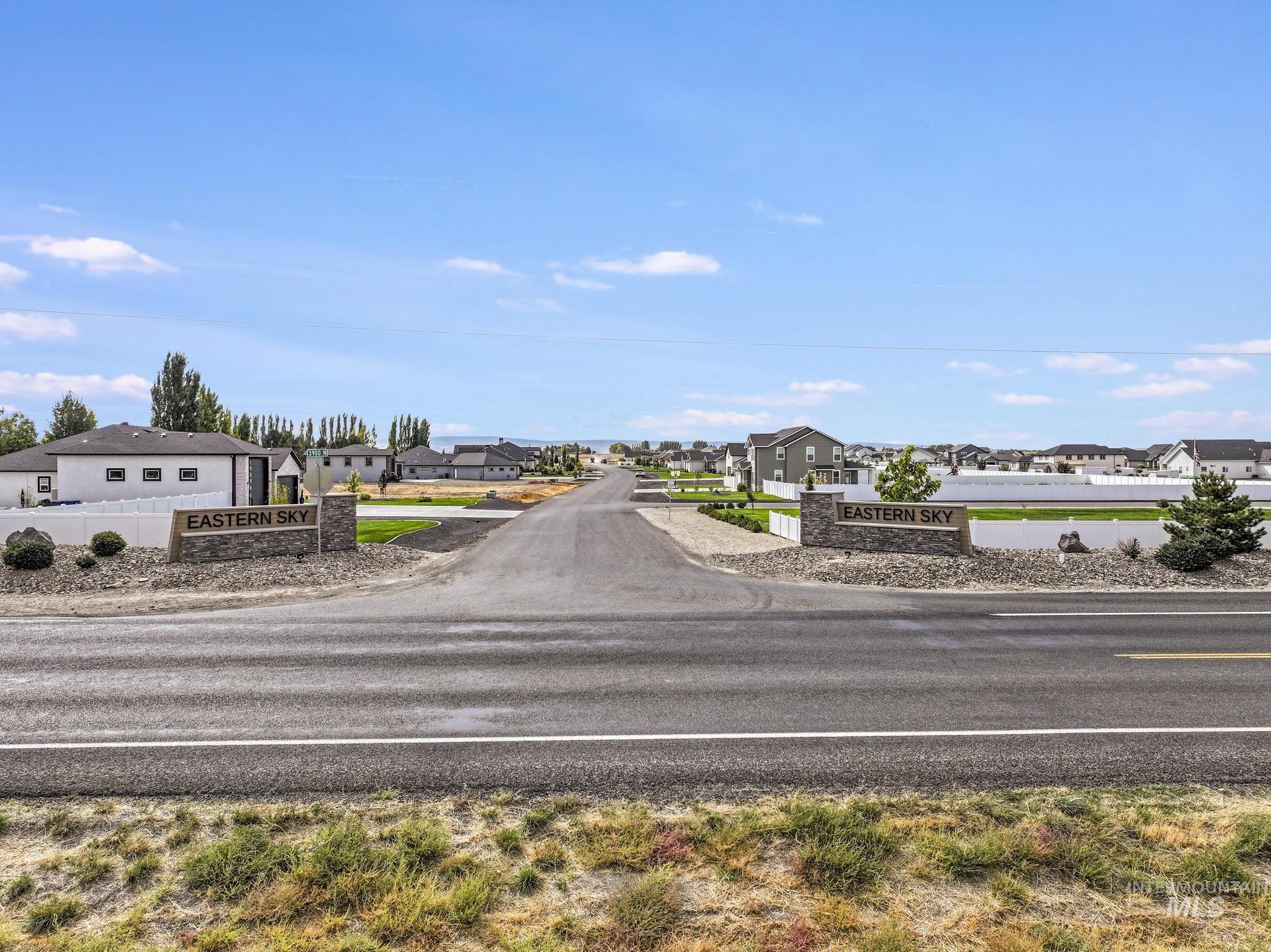 View of asphalt road featuring a residential view