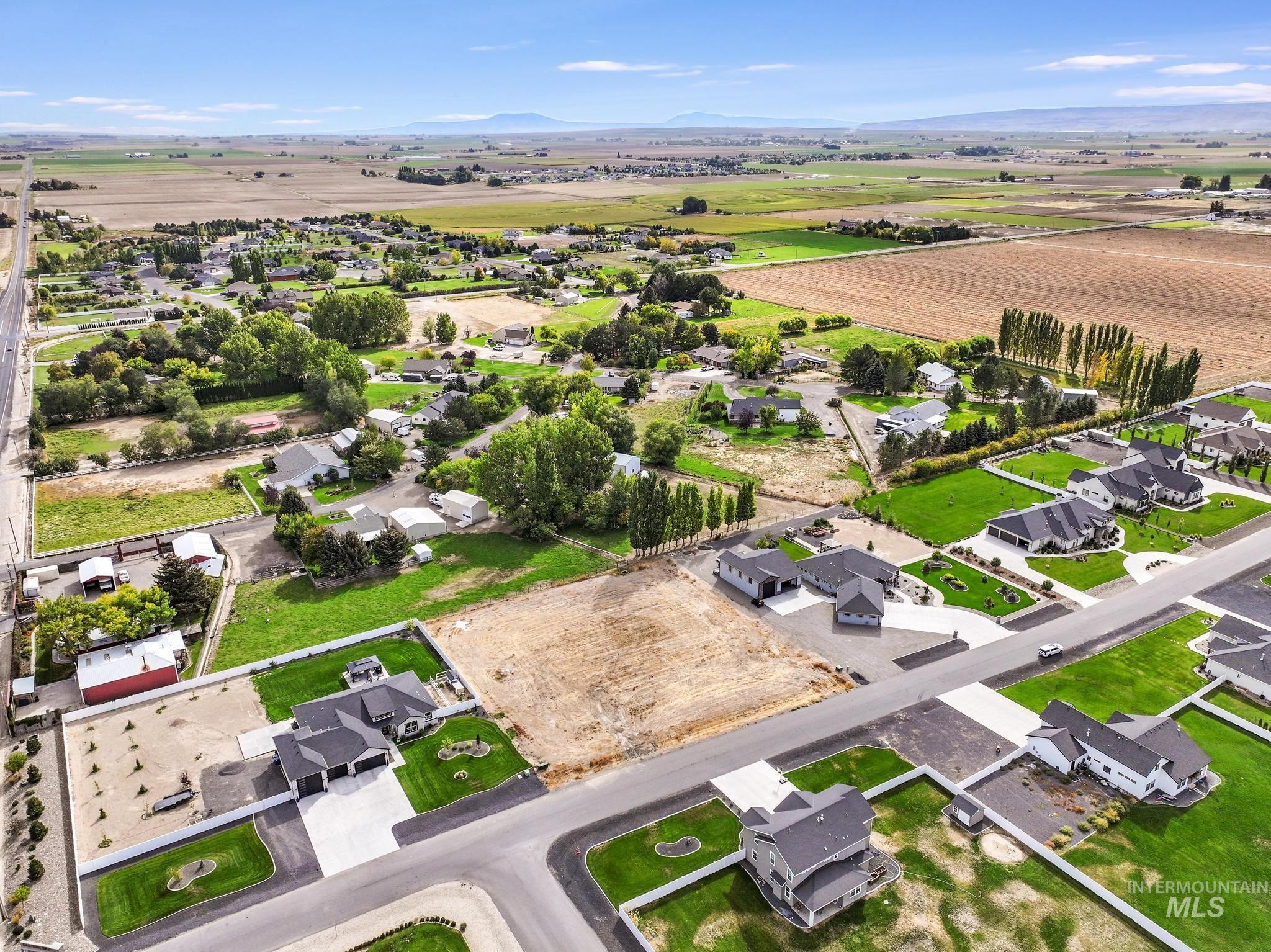 View of property location with nearby suburban area, a mountainous background, and rural landscape